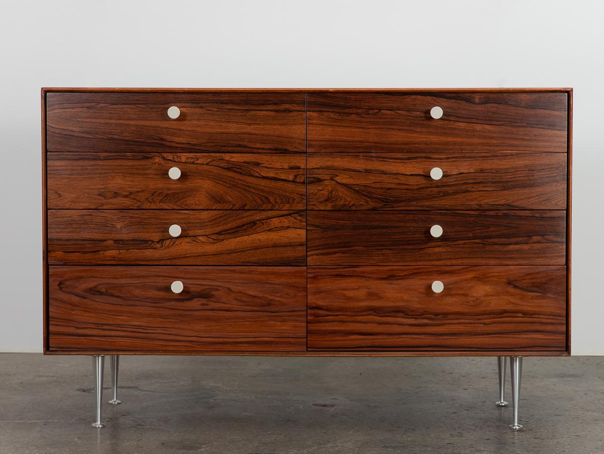 Spectacular rosewood Thin Edge collection model 5221 eight-drawer dresser, designed by George Nelson for Herman Miller. Drawer fronts show off gorgeous figured rosewood selection, finished with the designer’s signature porcelain knobs. Named for its