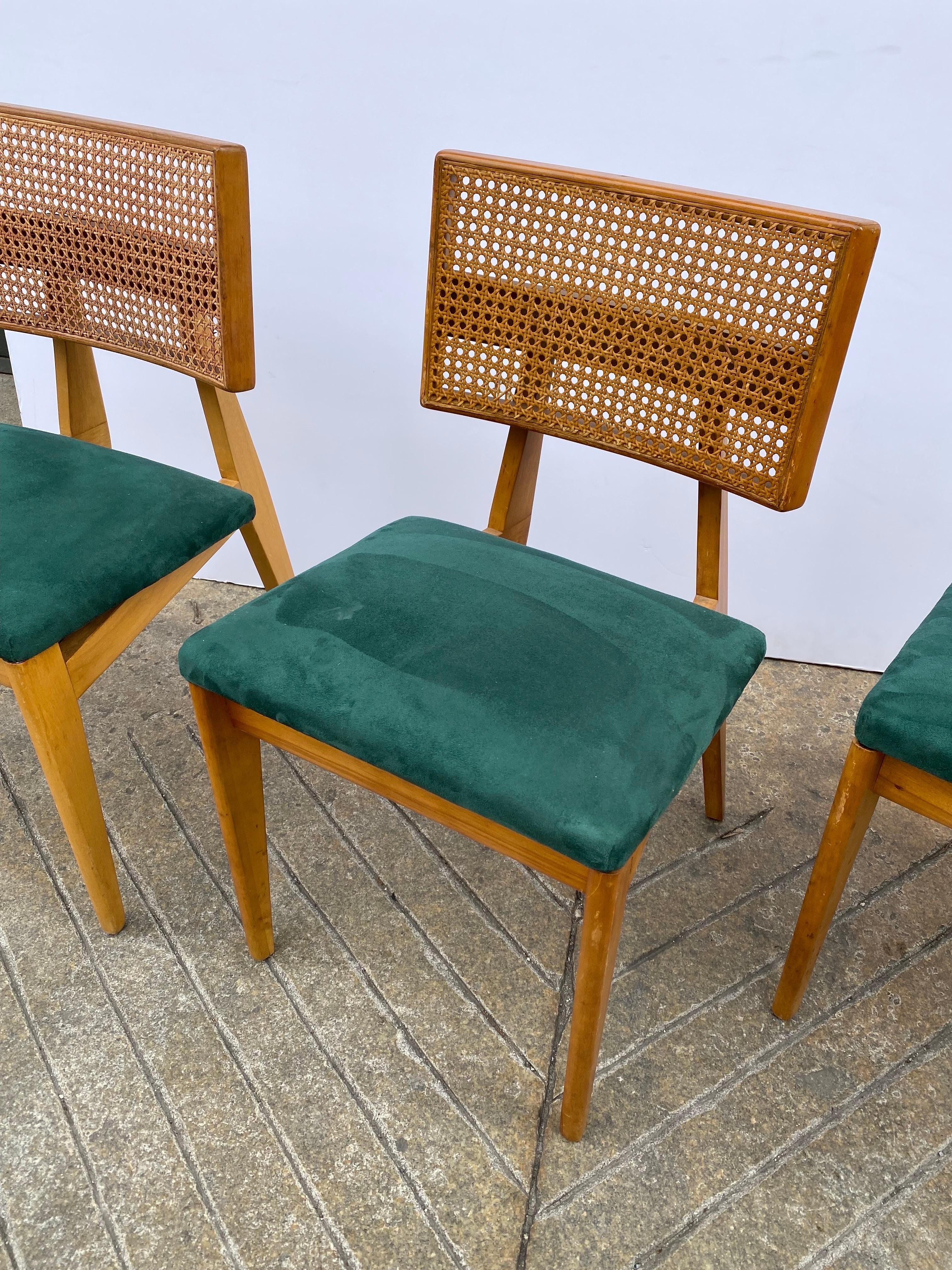 George Nelson set of 4 side chairs. Caned backs in good shape with Maple Frame construction. Some finish is a little worn as seen in photos. Upholstery is probably 15 years old and is ready for a redo.