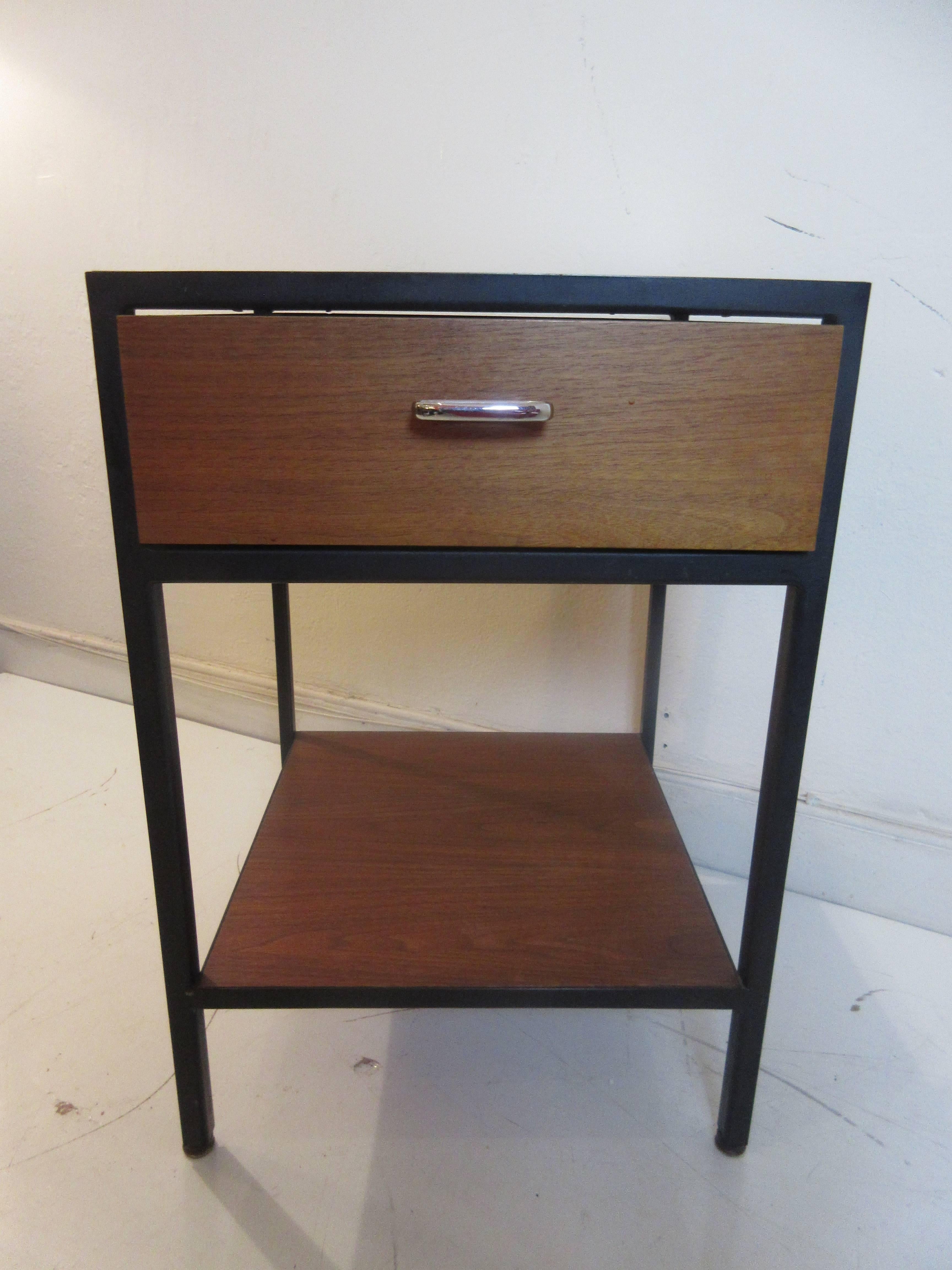 George Nelson for Herman Miller steel case nightstand in walnut panels and black steel frame. It retains its original foil Herman Miller tag. Laminate in great condition as is wood and paint on steel.