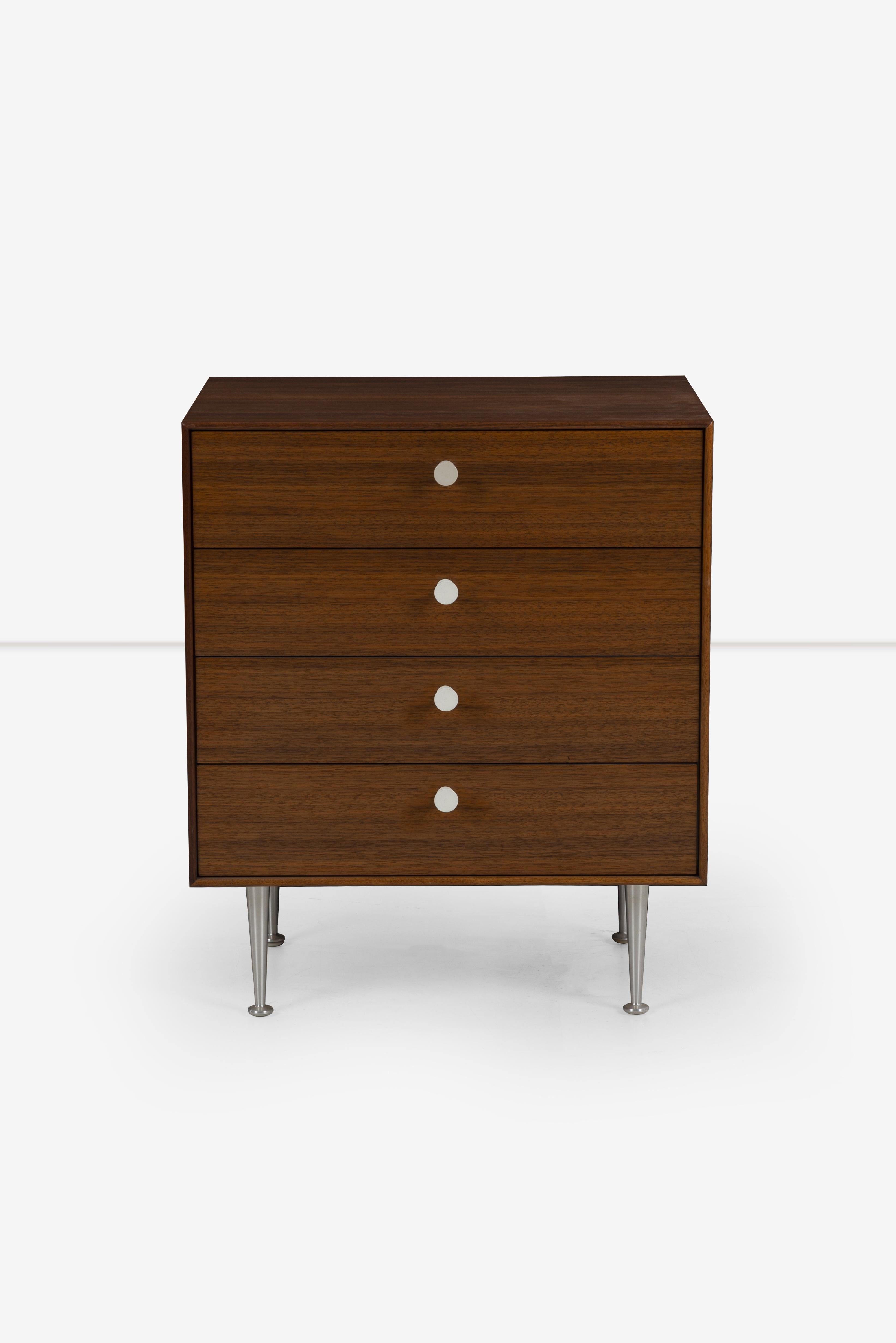 George Nelson for Herman Miller, Thin Edge Dresser in Oiled Teak-Wood 1956, Model 5202 Features teak grained veneer with aluminum tapered legs and porcelain pulls.
 