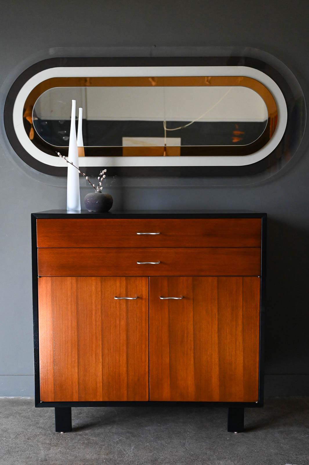 George Nelson for Herman Miller two tone cabinet, ca. 1950. Professionally restored ebonized mahogany with original drawer pulls, this beautiful cabinet has doors that open to adjustable shelving on the inside and two upper drawers with the original