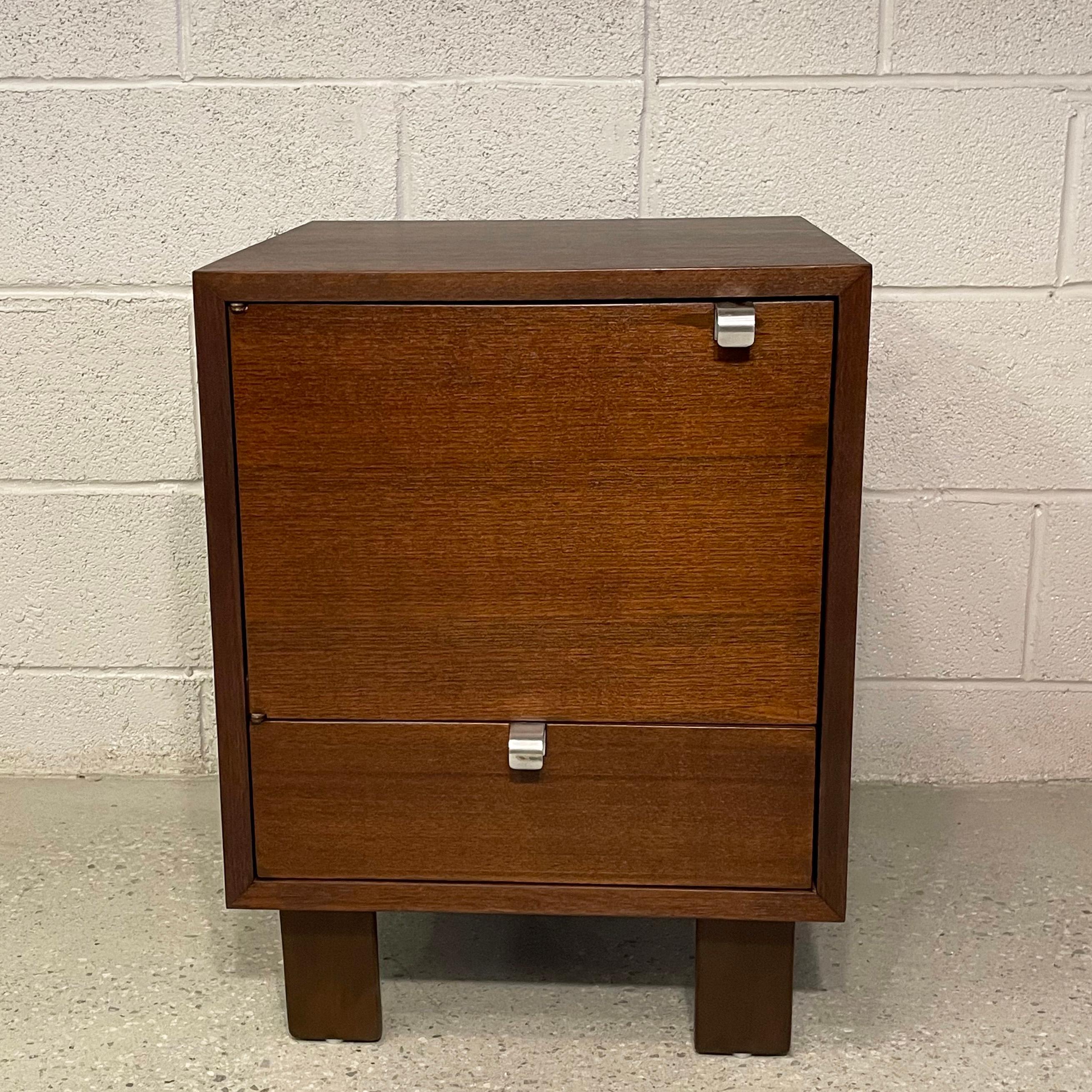 Mid-century modern, model #4617, walnut nightstand or end table by George Nelson For Herman Miller features closed storage with signature, steel J pulls. Iconic, American, mid-century design.