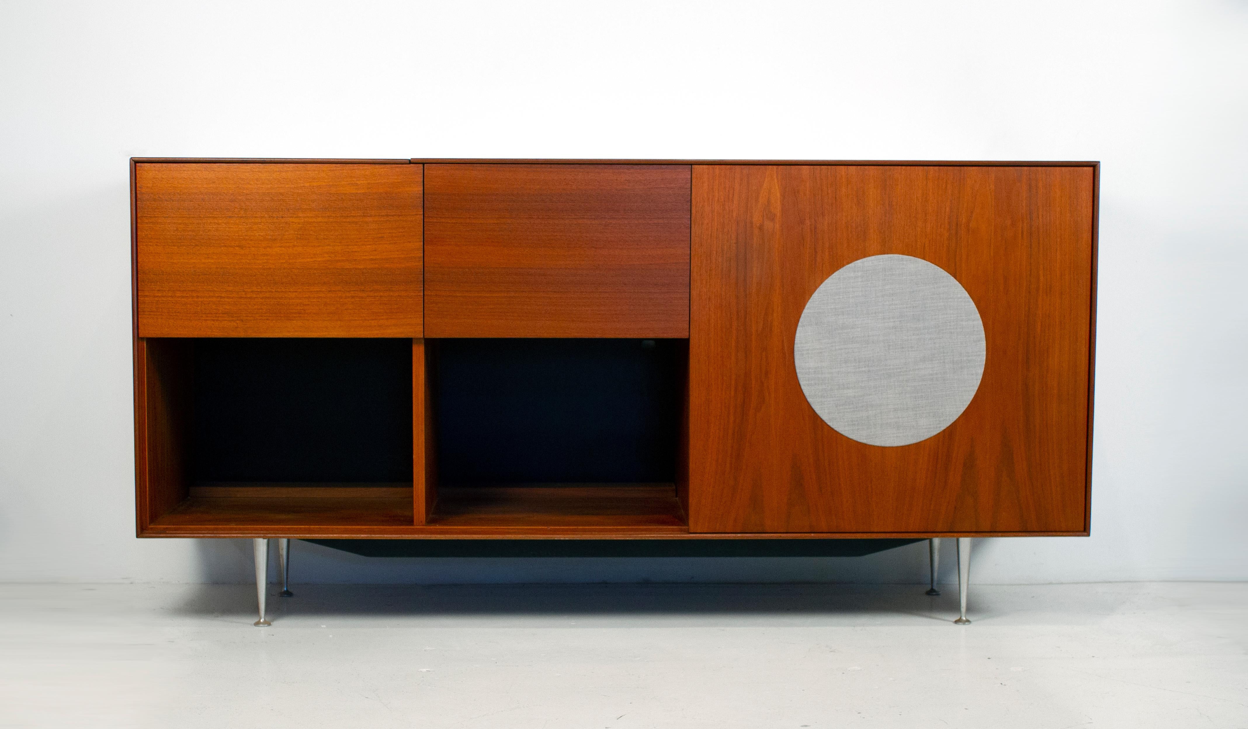 This Herman Miller cabinet was created in 1952. It is from the desirable thin-edge series and has a space for a single speaker, a flip open top for a turntable and a drop down compartment for your amplifier and receiver. It is in very good condition