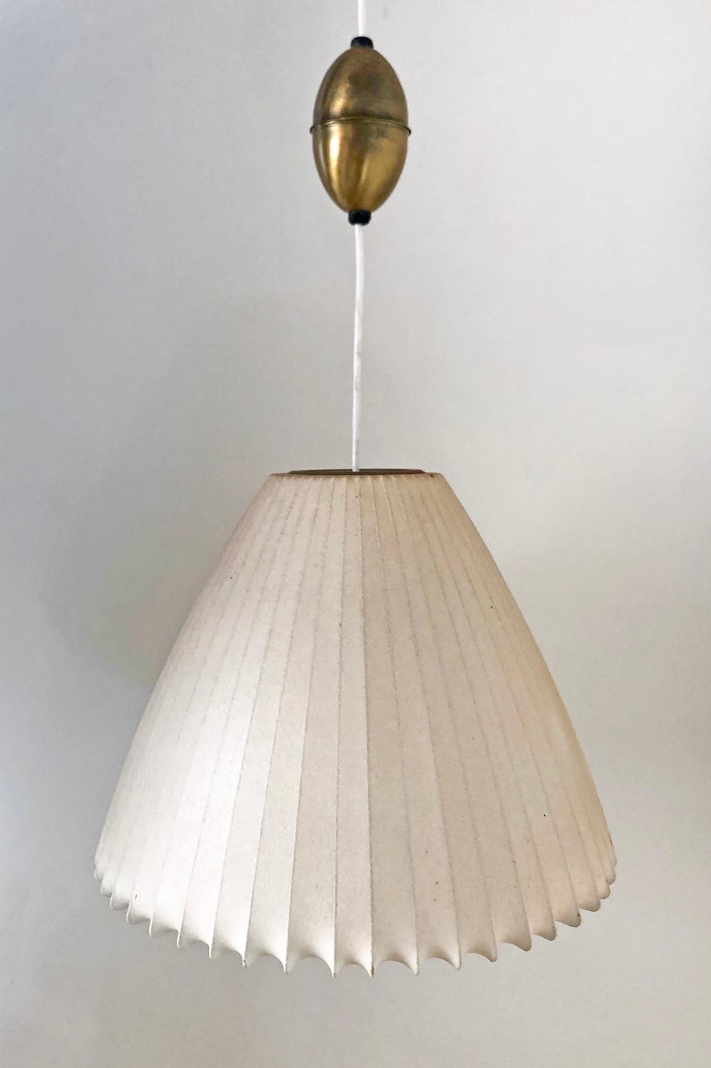 Designed in the 1950s this is one of the rarer George Nelson bubble lamp forms, the bell. This bell shaped pendant still retains its original Howard Miller labels, original patinated skin, and original brass components.

Pendant has original brass