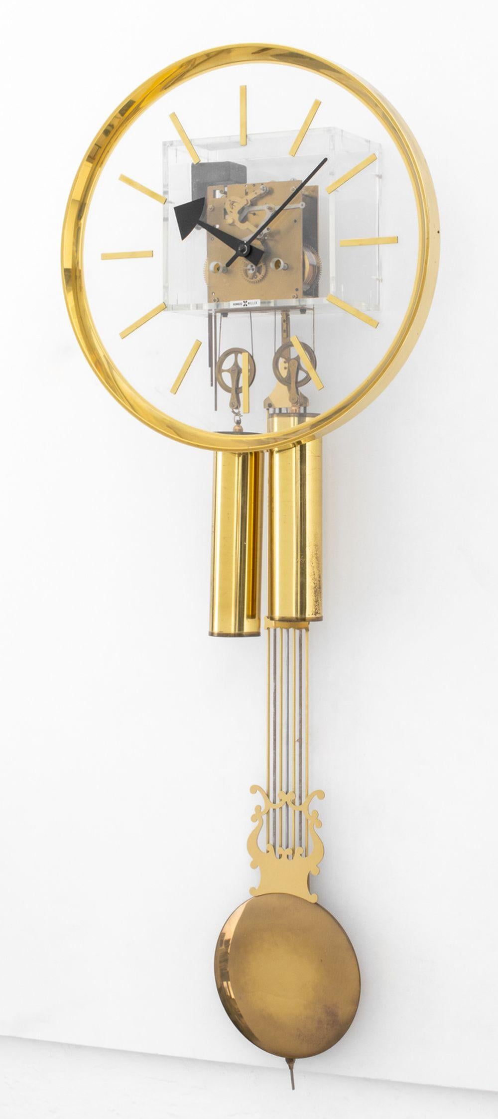 George Nelson for Howard Miller Brass and Lucite Wall Clock, hanging pendulum, label to transparent clock face. 40