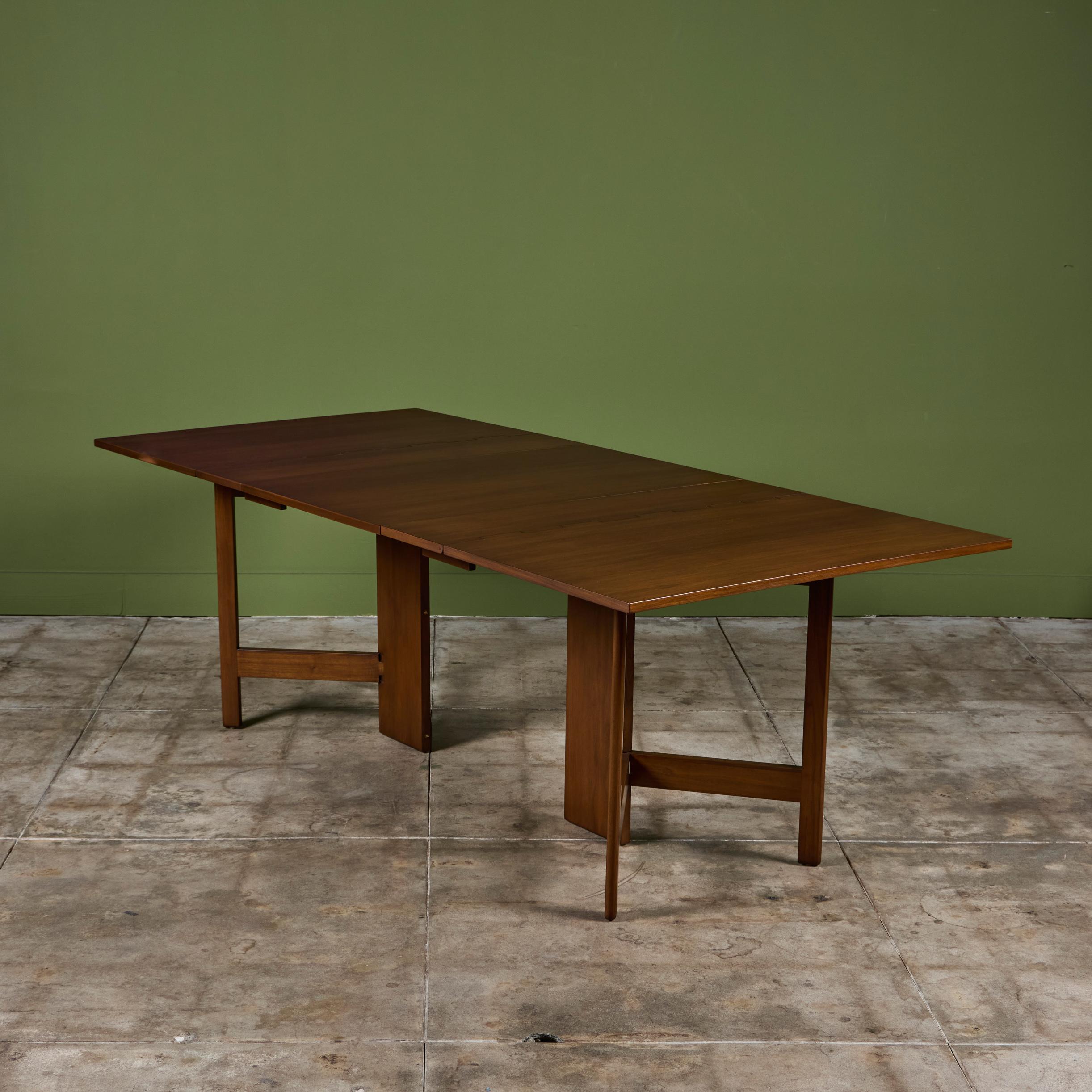 George Nelson expandable gateleg dining table table for Herman Miller, c.1950s, USA. The walnut table features beautiful dovetail joinery, two drop leaves and a center leaf. The table can extend up to 88.75