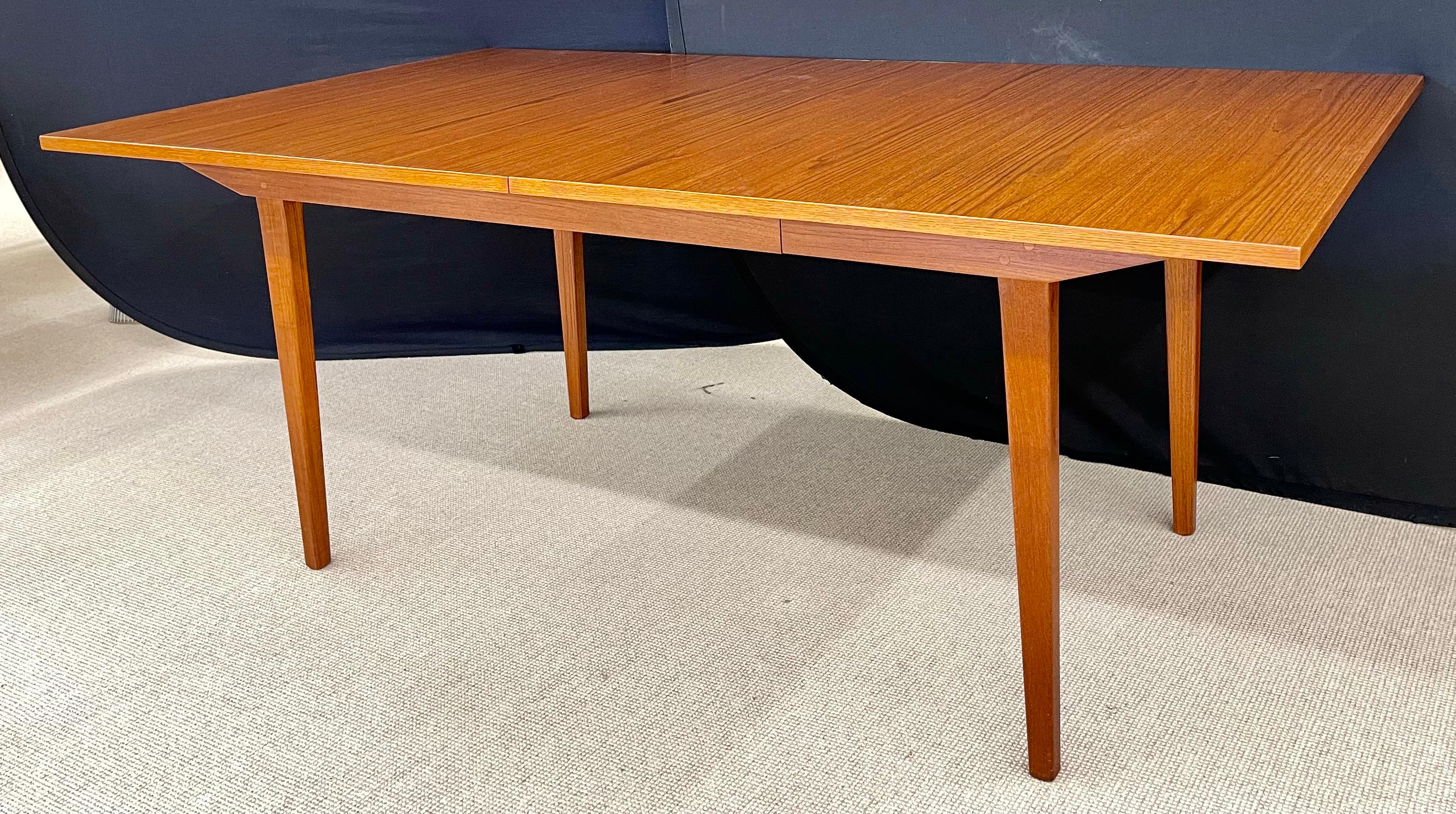 George Nelson & Associates dining table in teak wood for Herman Miller. This table is in pristine condition. Hide away leaves. Two 20 inch leaves, Part of our extensive collection of over forty dining tables and chair sets as seen on this site, thus