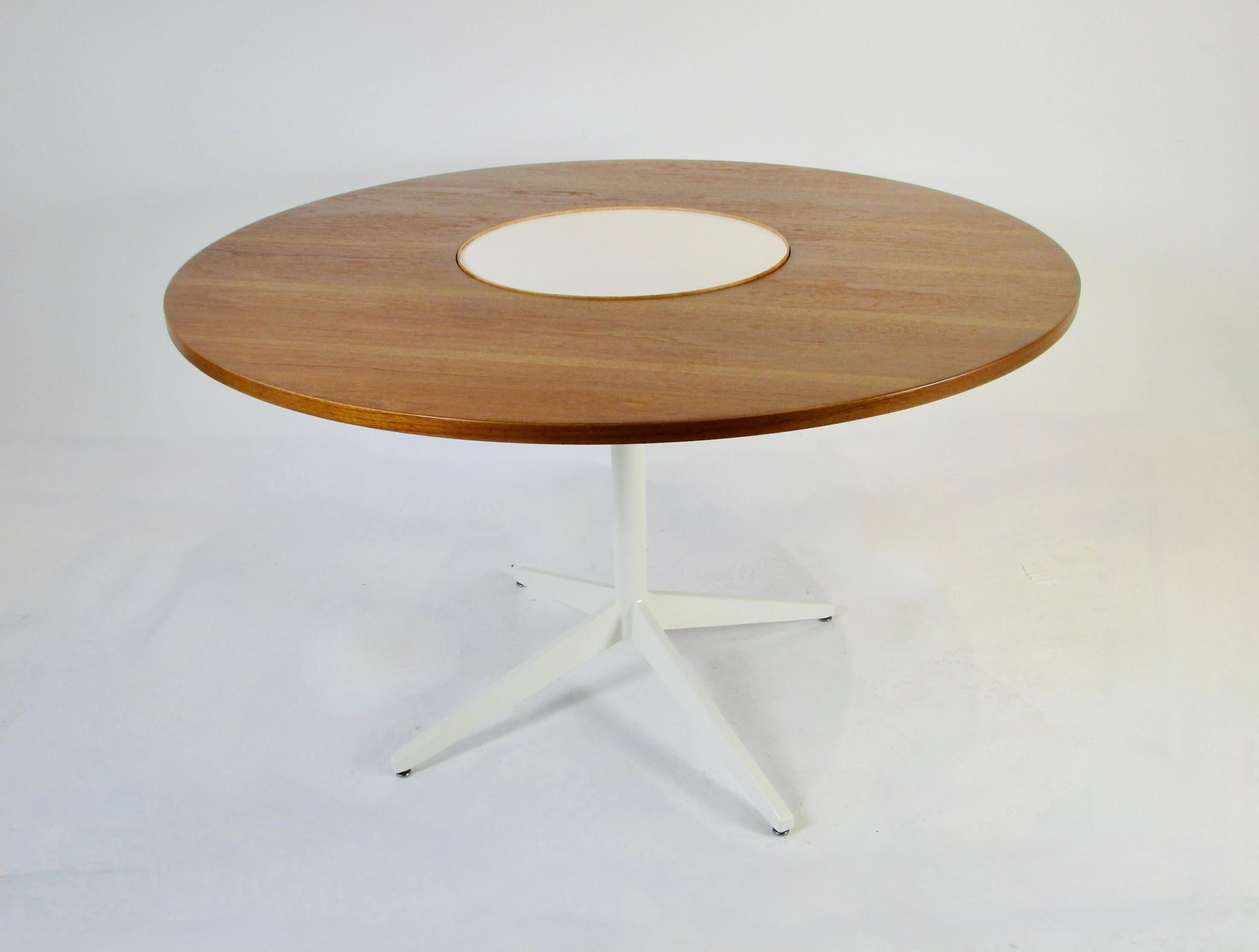 Early and on the rare side. Teak with white laminate lazy susan center dining table. Designed by George Nelson for Herman Miller. The center white laminate area is a rotating lazy susan makes for fun serving. This is the only example I have ever