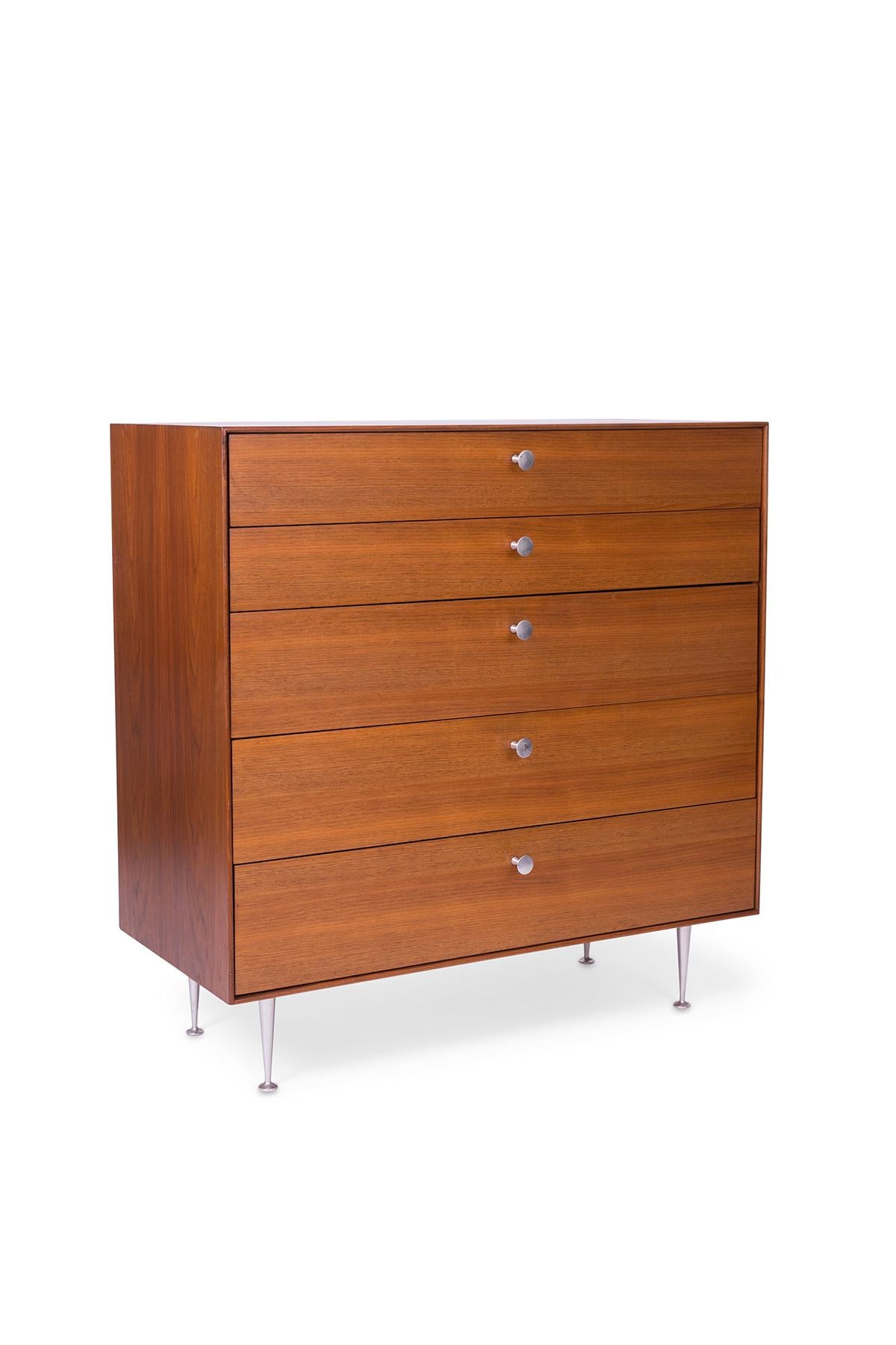 George Nelson for Herman Miller highboy dresser, circa early 1960s. This all original example has beautifully grained walnut case and drawer fronts. Original thin edge legs and pulls.