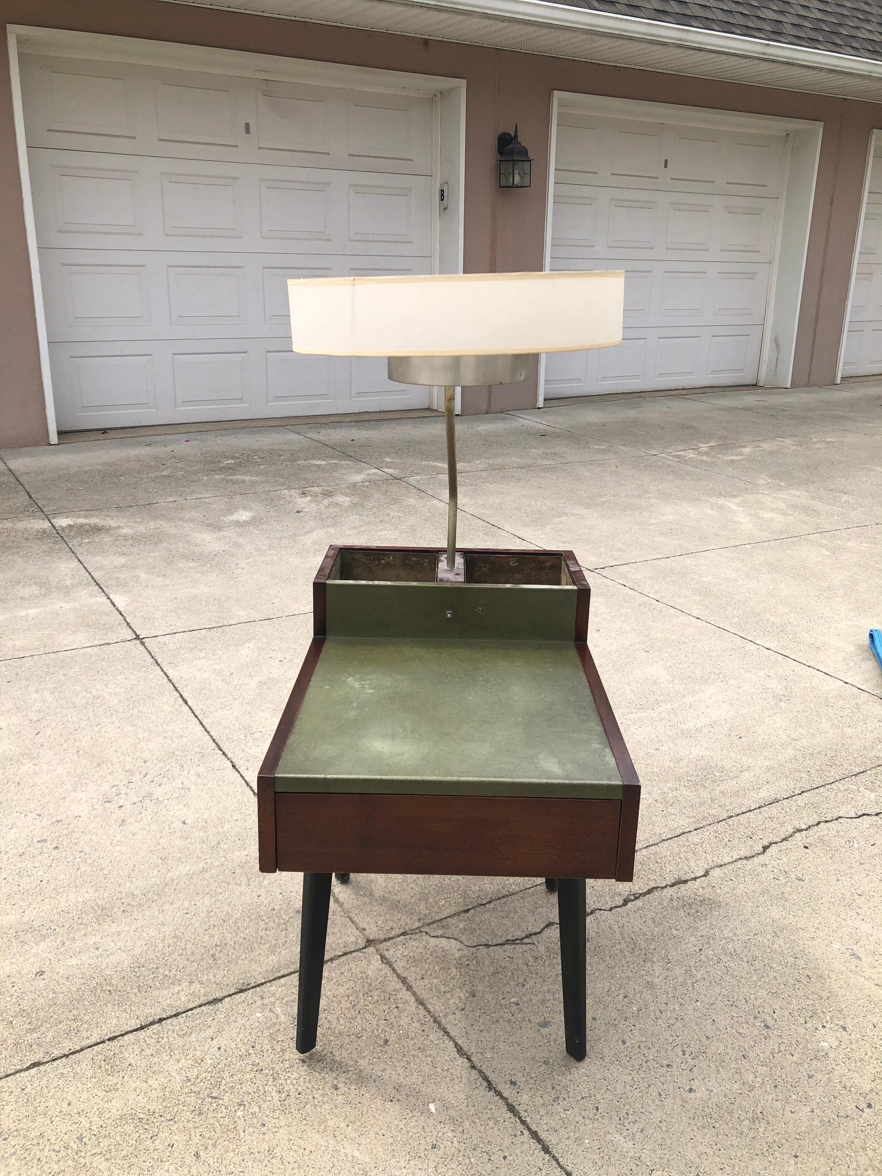 Unique and rare Mid-Century Modern Model 4634-L side table with lamp and planters designed by George Nelson for Herman Miller, circa 1940s. Featuring a handsome walnut case with a coordinating and complimenting leather tabletop. A lamp rises from