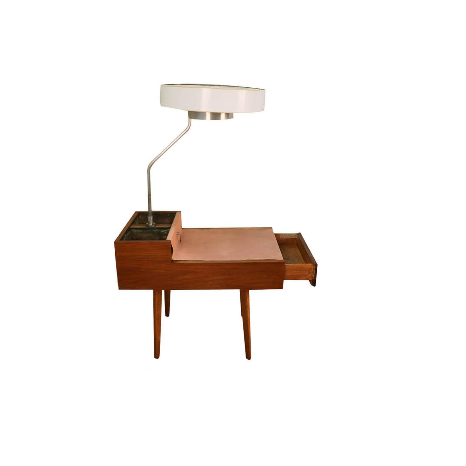Unique and rare Mid-Century Modern Model 4634-L side table with lamp and planters designed by George Nelson for Herman Miller, circa 1940s. Featuring a handsome walnut case with a coordinating and complimenting leather tabletop. A lamp rises from