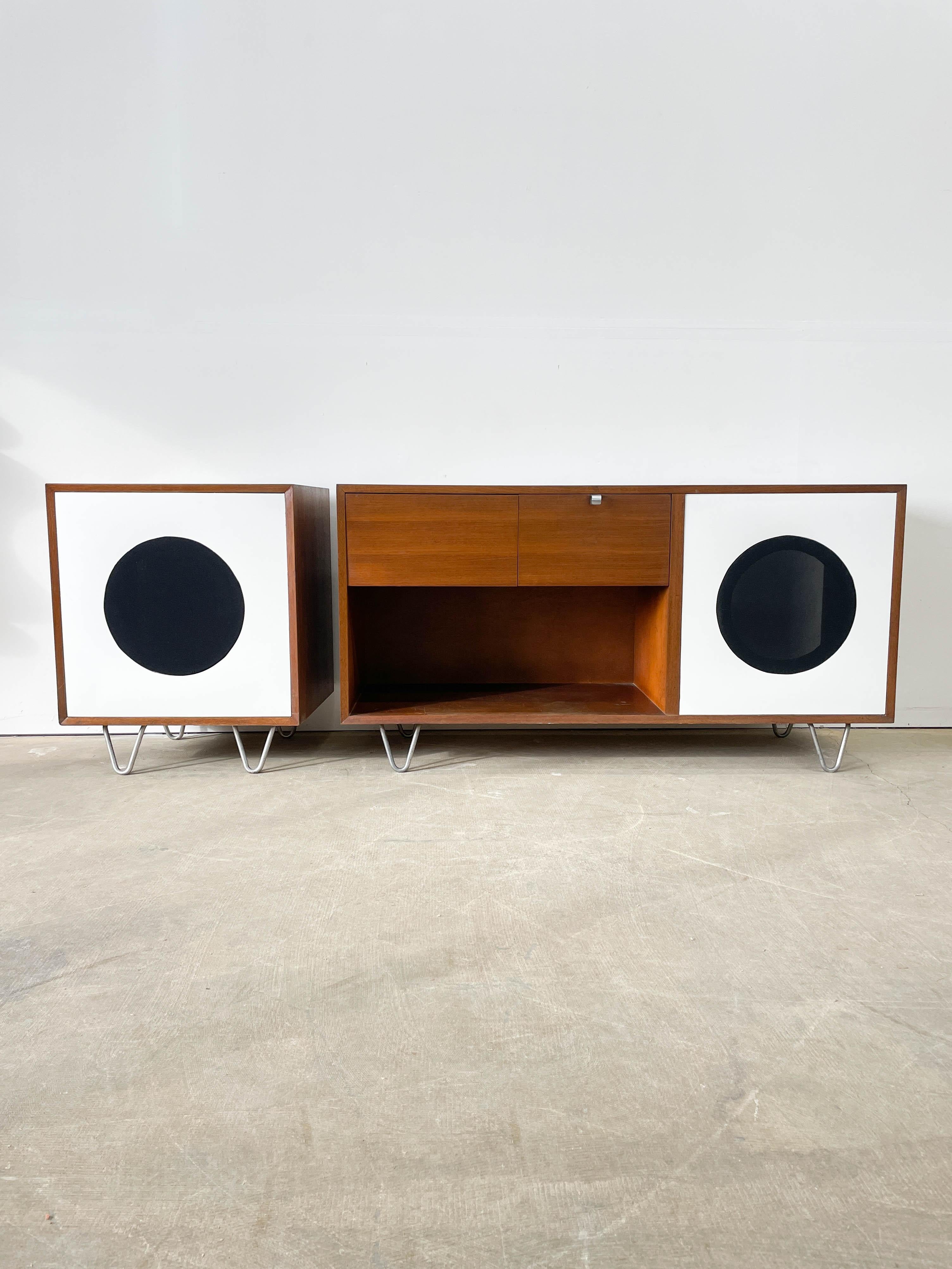 This is a classic George Nelson minimalist record player cabinet and satellite speaker cab from the Basic Cabinet Series (BCS) group of the 1940s. Made by Herman Miller with beautiful walnut cases, iconic hairpin legs and original hardware. These