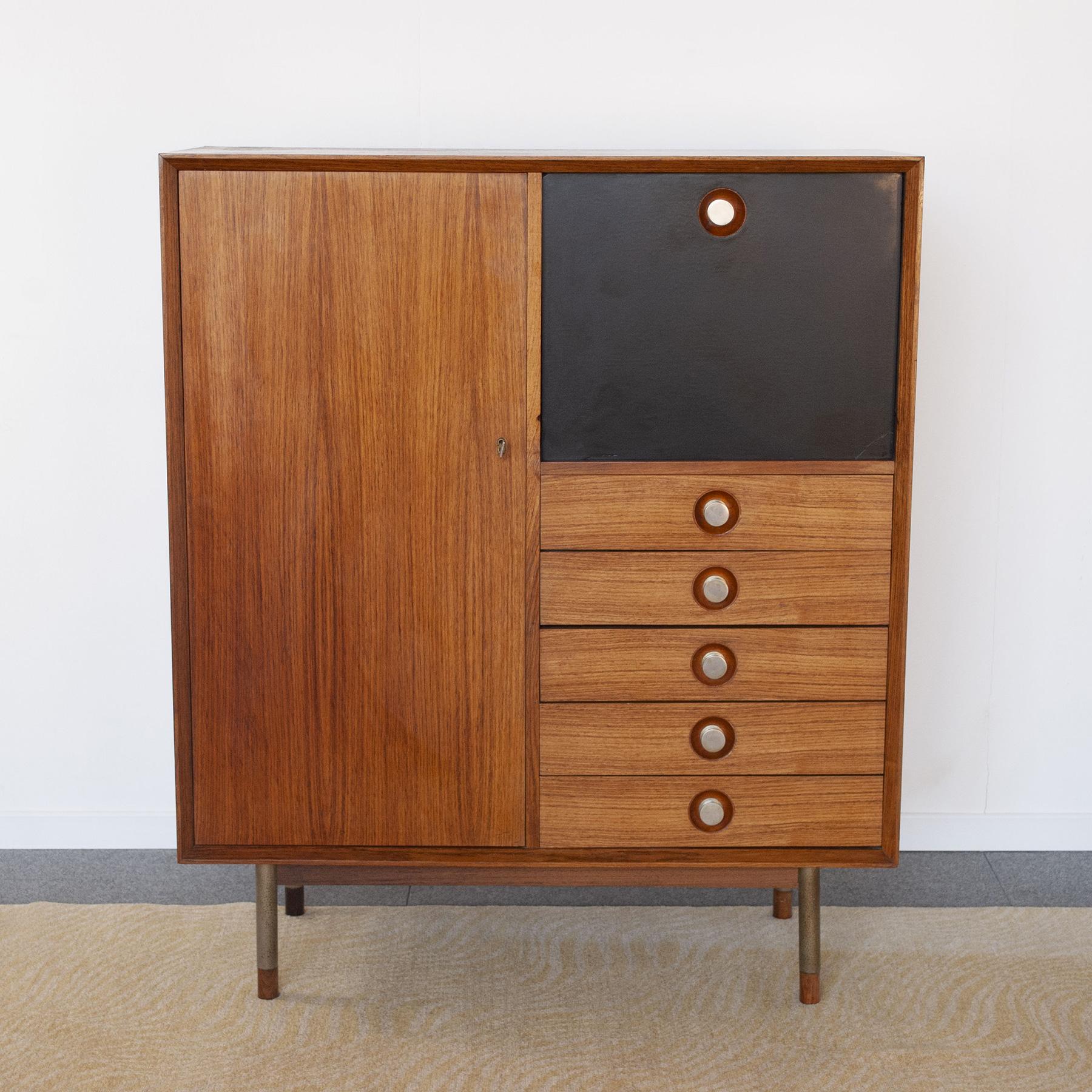 High board in walnut wood composed of a compartment with 5 drawers and a glass compartment and an opening door with lock designed by Georges Nelson, 1960s production.