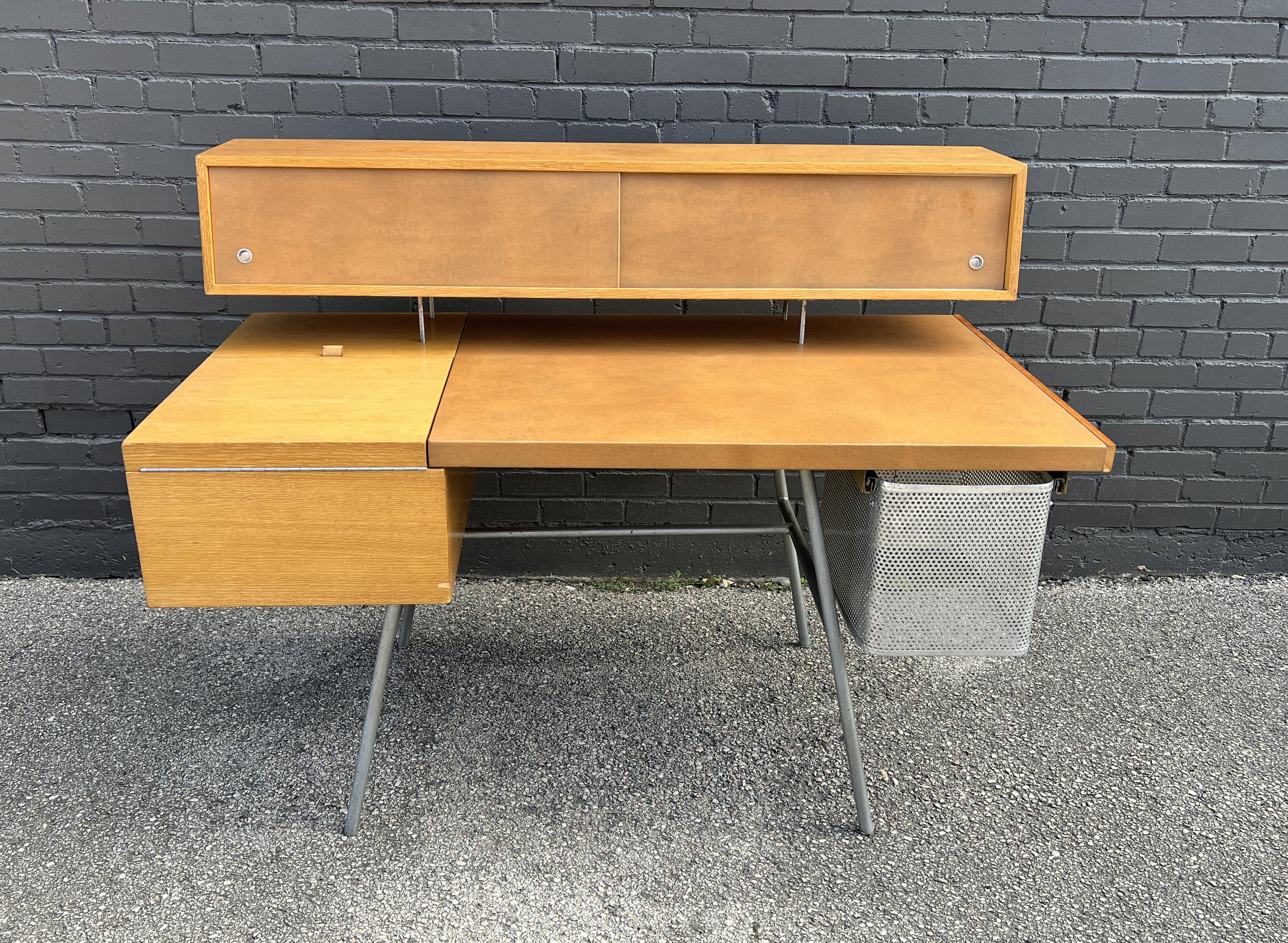 George Nelson & Associates
Home Office desk, model 4658
Manufactured by Herman Miller
USA, 1946
This example is constructed of combed oak, chrome-plated steel, aluminum, and leather.

The desk features a flip-top compartment concealing three