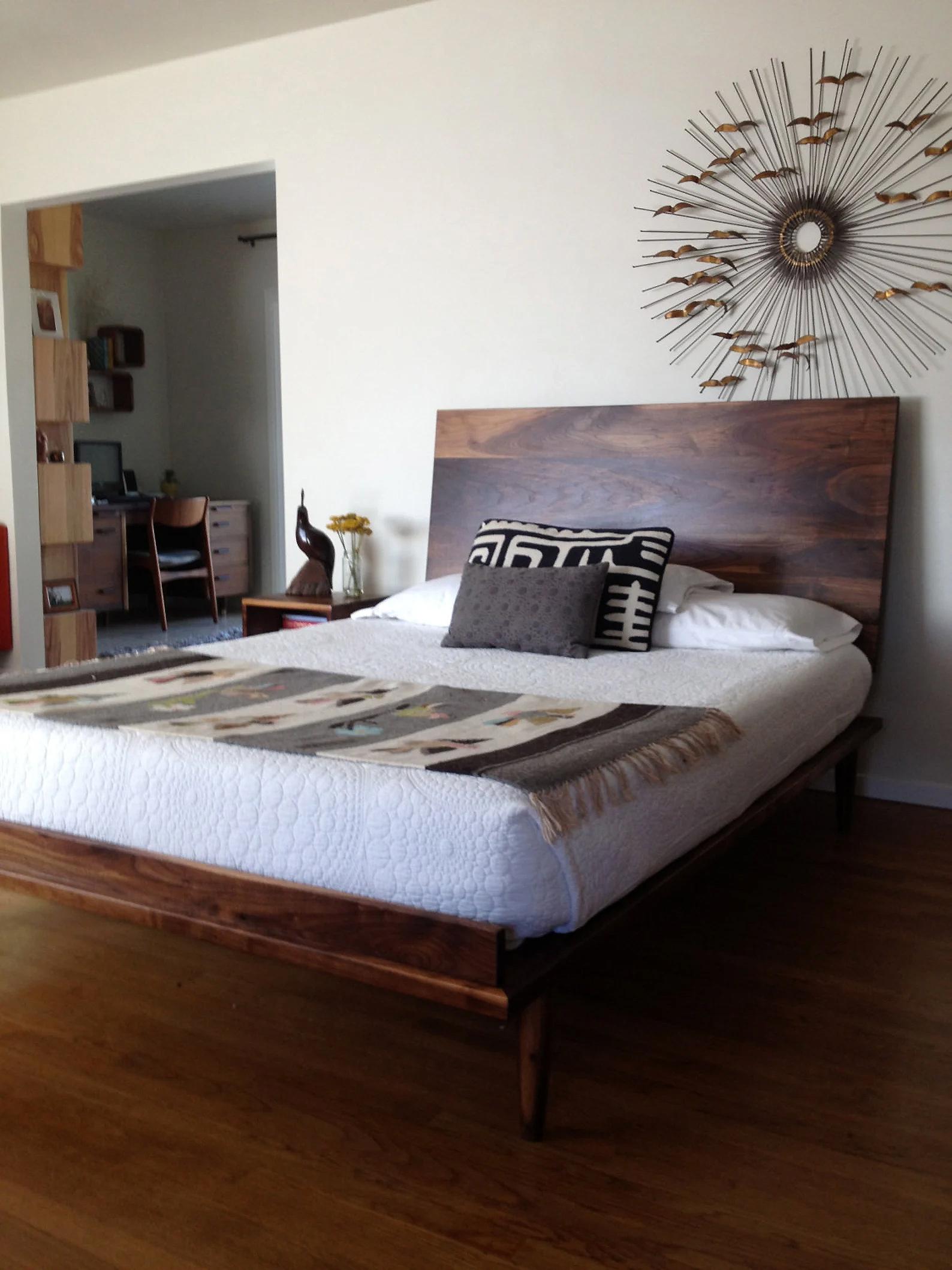 This bed is my own take on the iconic George Nelson Bed from the heyday of Mid Century Modern. It's built from solid walnut and consists of a thin platform resting on turned legs and a headboard supported by steel brackets. It has a hand-rubbed oil