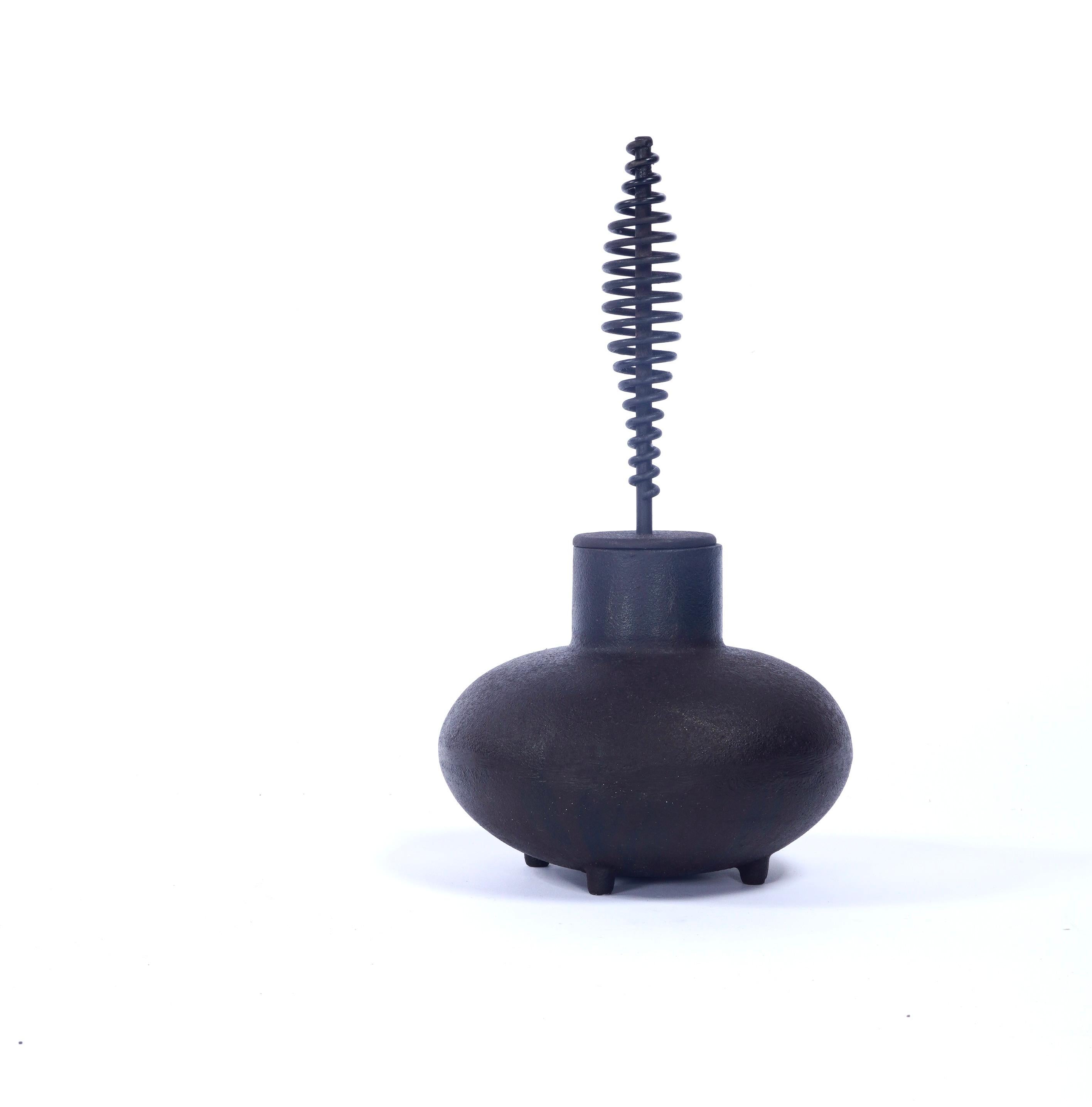 Irving Harper for George Nelson Associates & Howard Miller fire starter in cast iron. The iron pot is to filled with an accelerant in which the stone end of the wand soaked, when lit with a match it would used to set the kindling a fire. Harper