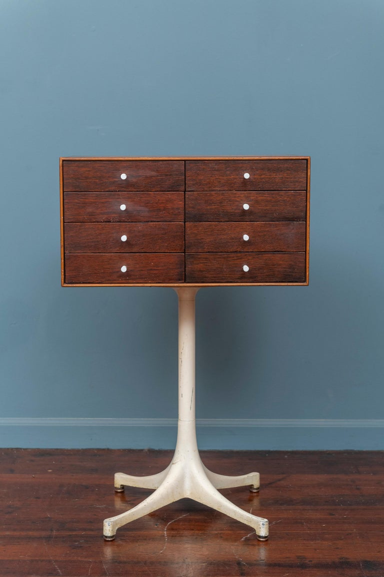 George Nelson design jewelry cabinet for Herman Miller, 1950's. Rare eight drawer model as opposed to the more common four drawer single door version. Made from teak with rosewood drawer fronts, porcelain pulls and one jewelry tray. Enameled base