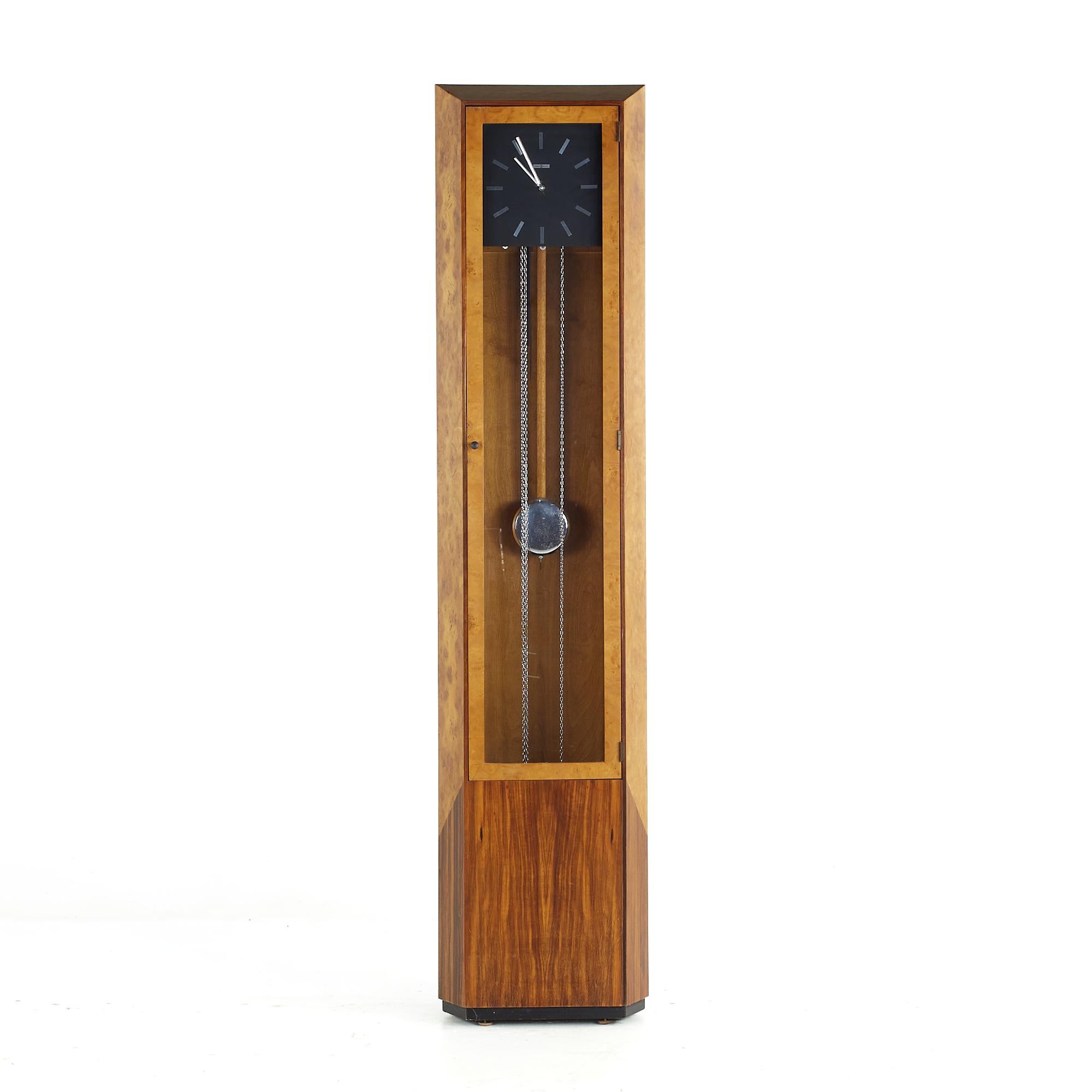 George Nelson Mid Century Burlwood and Rosewood Grandfather Clock

This clock measures: 16.5 wide x 9 deep x 72.5 inches high

We take our photos in a controlled lighting studio to show as much detail as possible. We do not photoshop out
