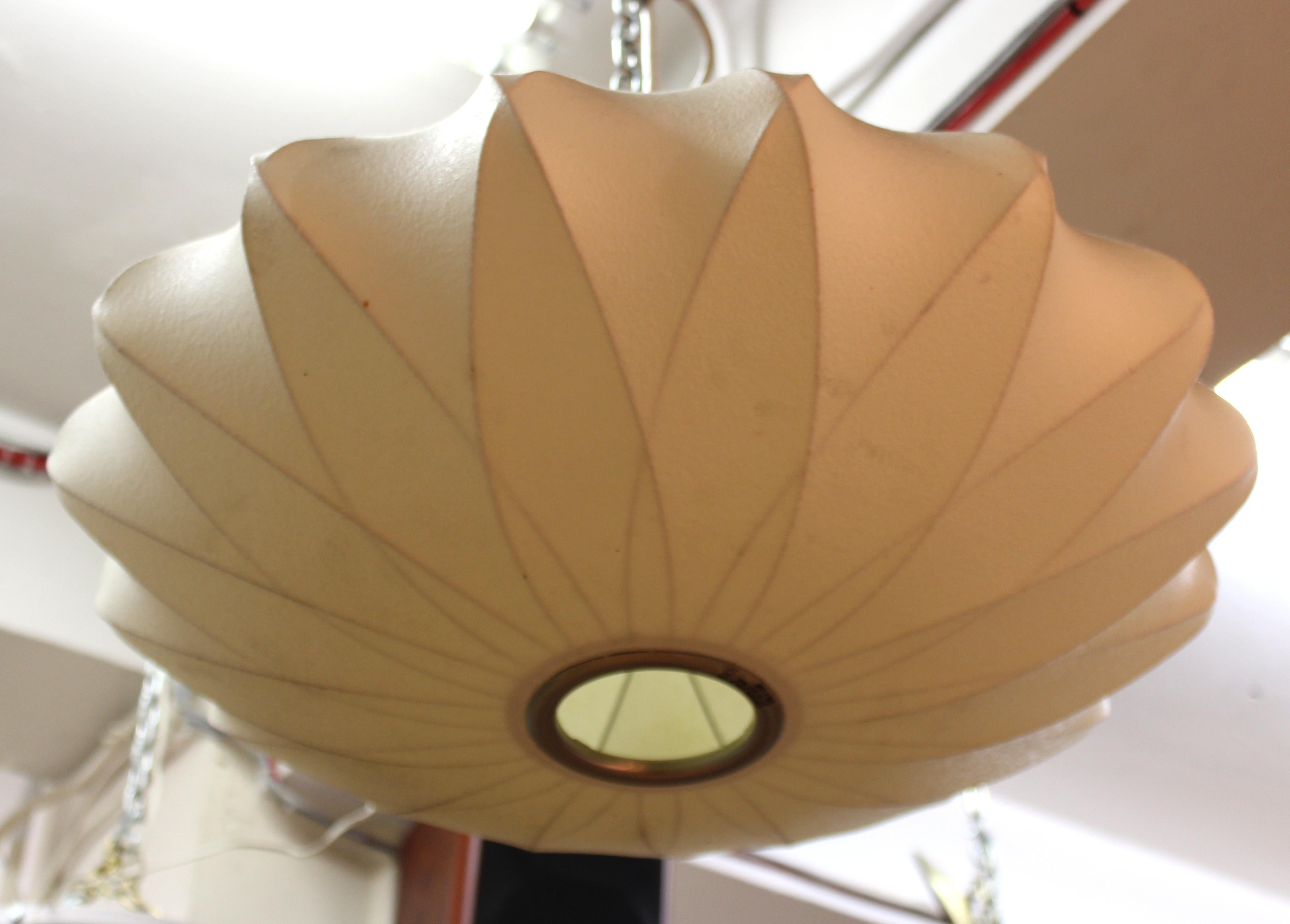 Mid-Century Modern cocoon ceiling pendant light designed by George Nelson. The piece was made in the 1960's and has a resin cover. In great vintage condition with age-appropriate wear and use.