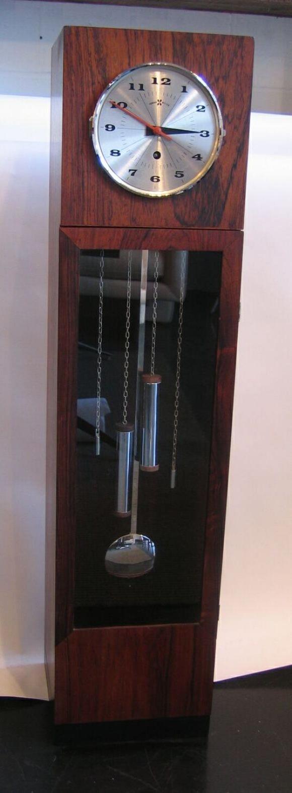 Beautiful half-height tabletop grandfather clock in rosewood. Designed by George Nelson for Howard Miller clock company. Wind-up mechanism. Weights and pendulum are purely decorative.