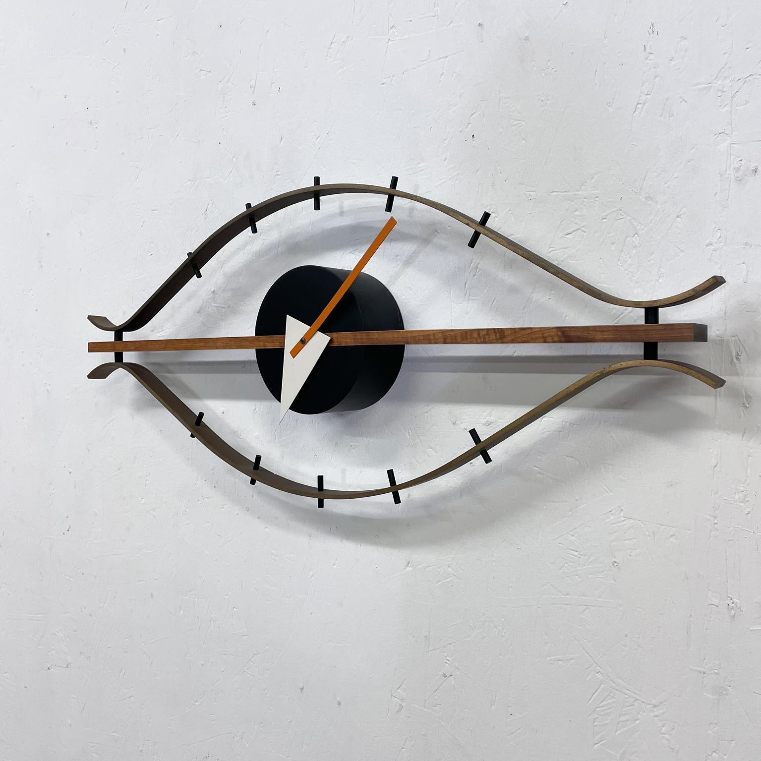 For your consideration: George Nelson modern Eye Clock 
Walnut wood and brass
Designed by George Nelson 1957 made in Germany
Vitra Re-Edition 2001 authorized Re edition maker label present
Vitra Design Museum presents a re-edition