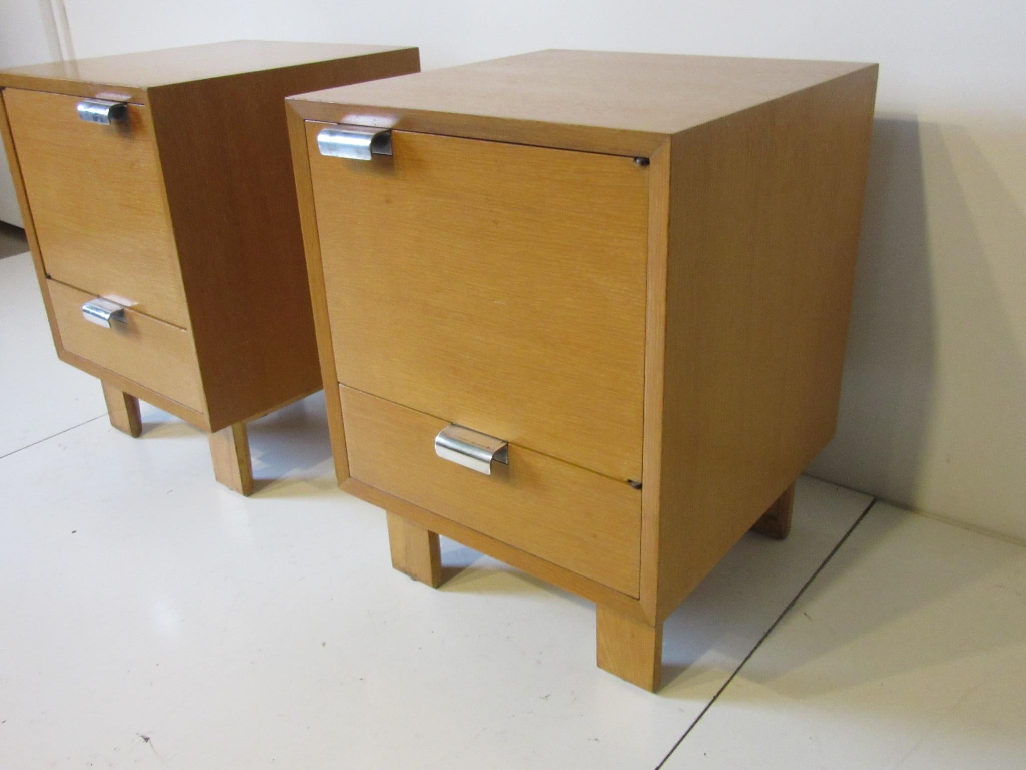 A pair of combed oak nightstands model # 4617 with left and right hinged doors and lower drawer with larger and heavy duty special ordered silver plated J pulls. Inside the nightstands have a generous amount of room with the door backs having two