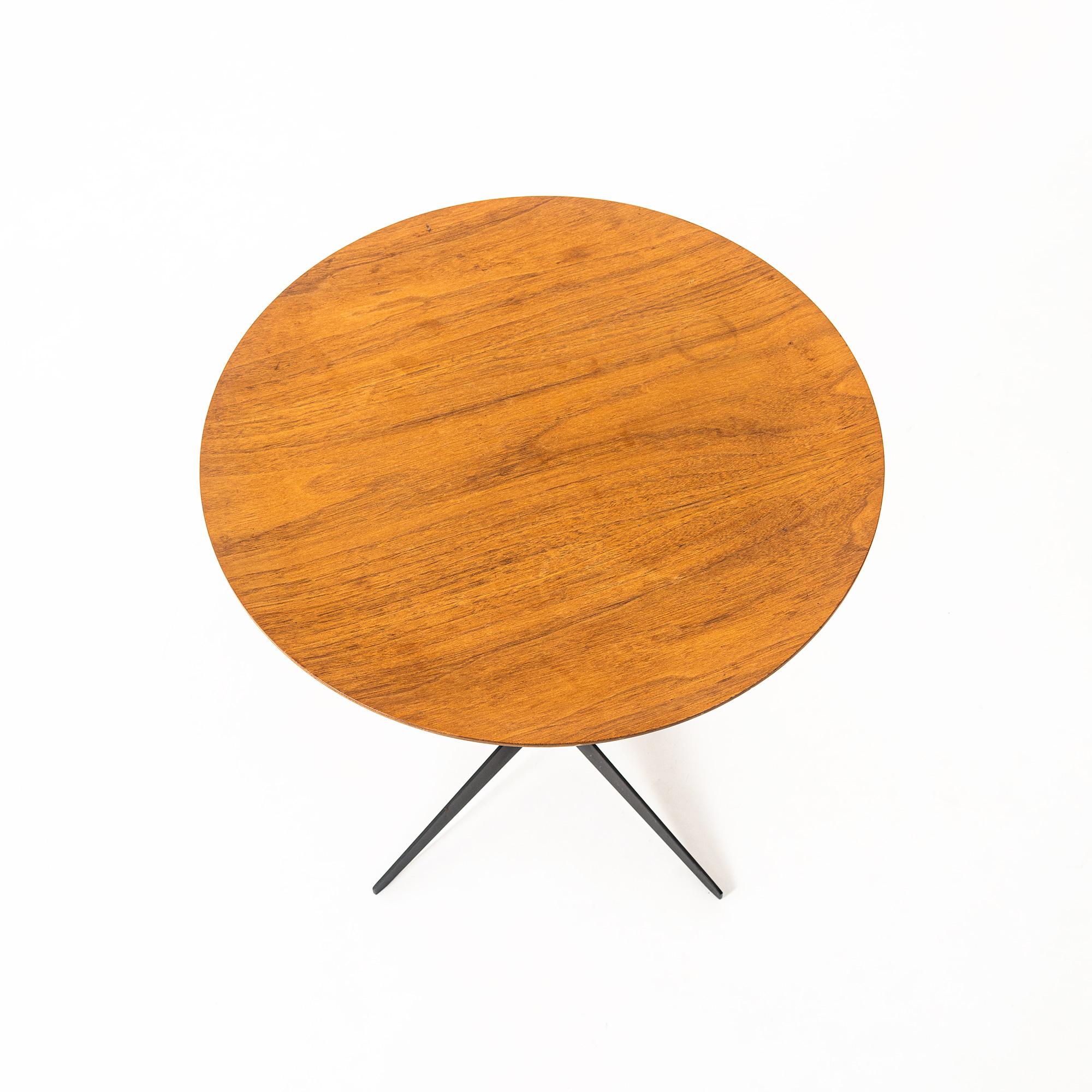 A pair George Nelson for Herman Miller tray tables, having a circular walnut plywood top, above a steel standard, continuing to enameled steel legs. This version has been discontinued and is rare to find with a wood top, circa 1950s.