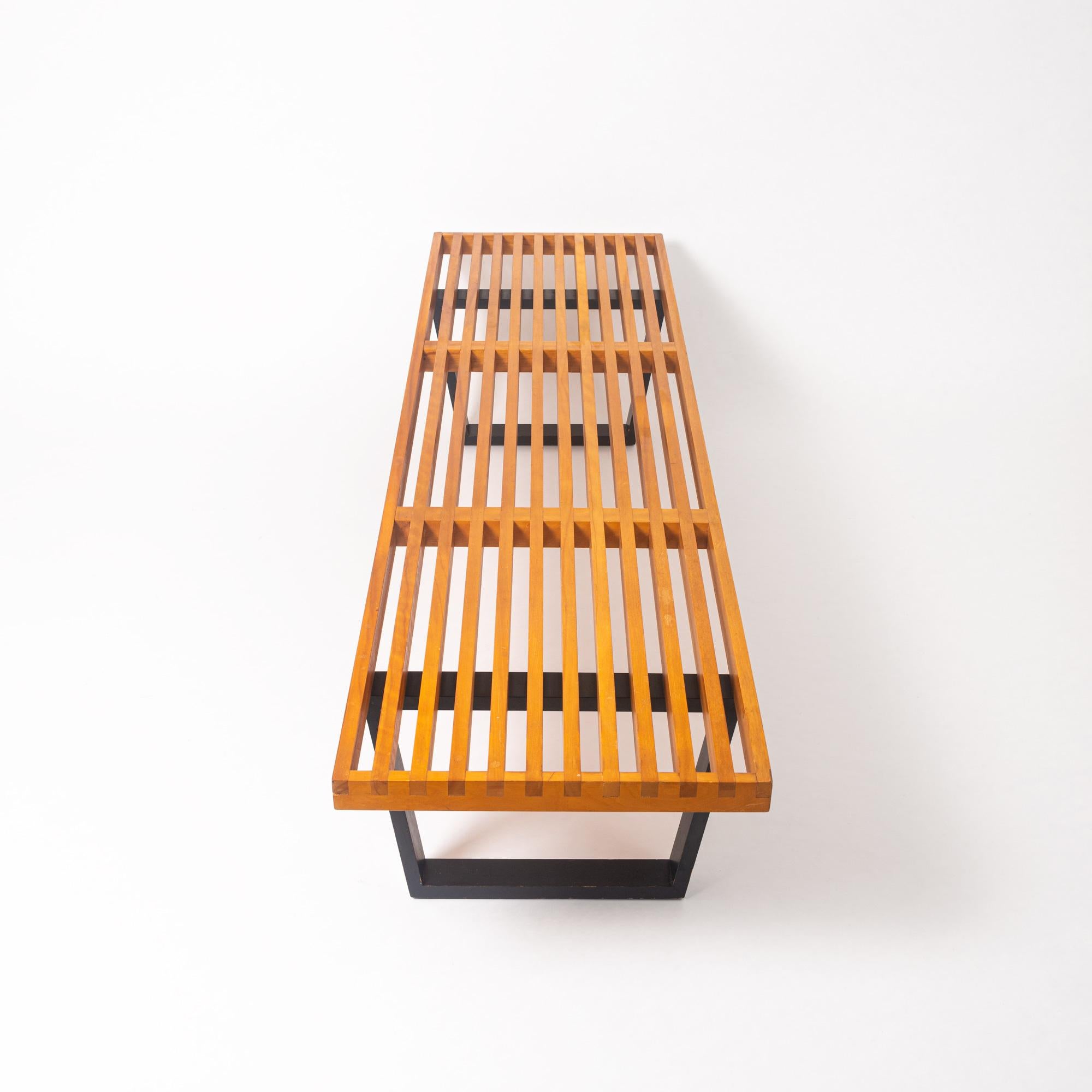 An iconic piece originally designed by George Nelson for Herman Miller, this early 1950s long bench is also very practical and is multi-functional. As an original 1950s piece, this long bench has a beautiful, rich yellowed patina and “crackled”