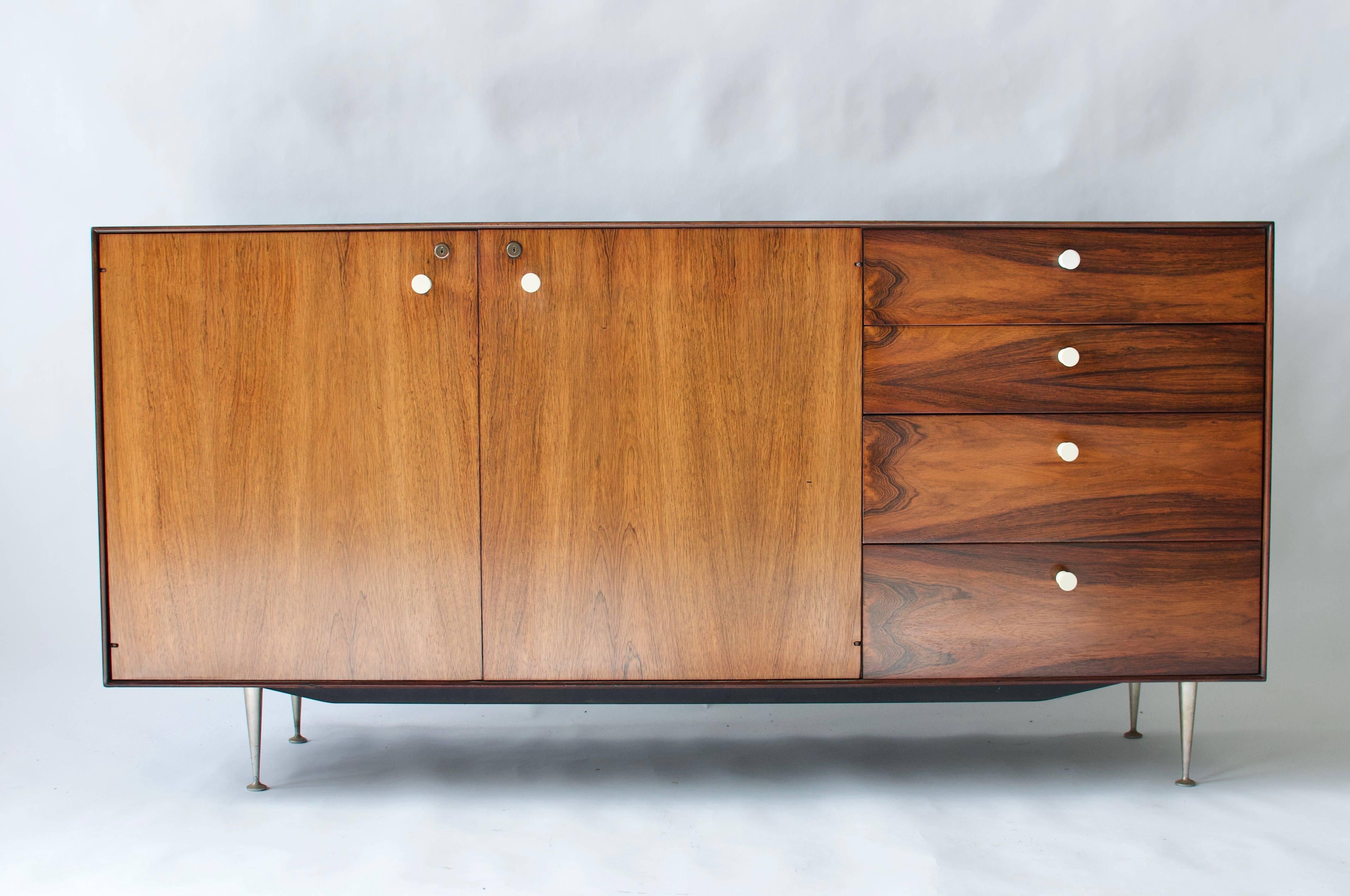 George Nelson rosewood thin edge cabinet for Herman Miller. Four drawers and two doors. Cast aluminium legs.