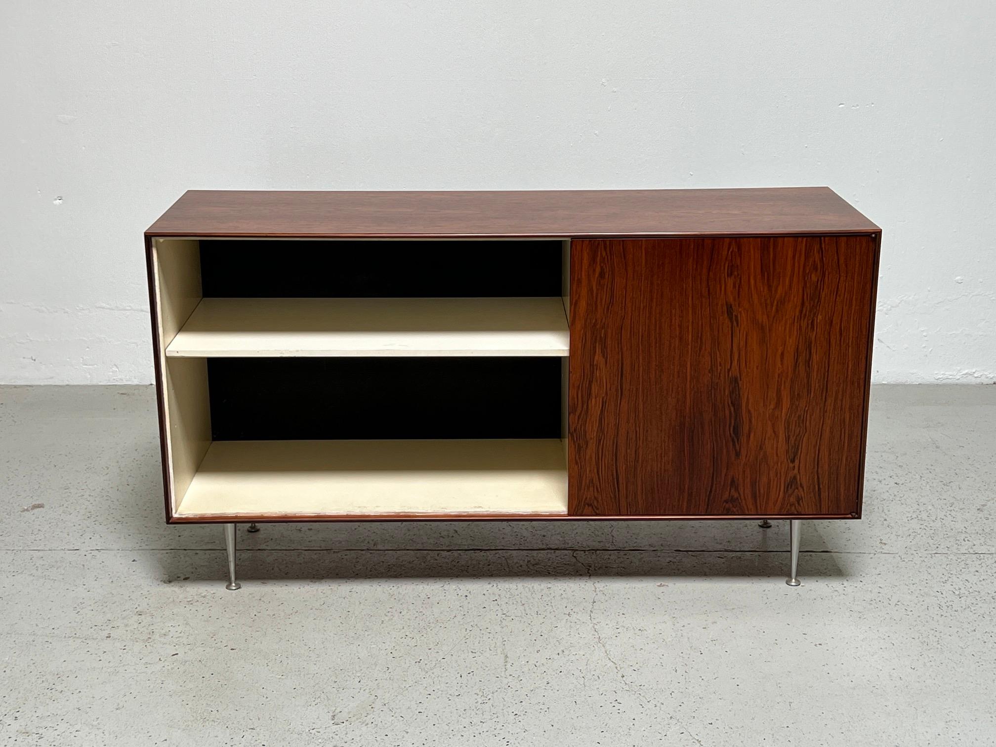 A rosewood thin edge cabinet / bookshelf designed by George Nelson for Herman Miller.