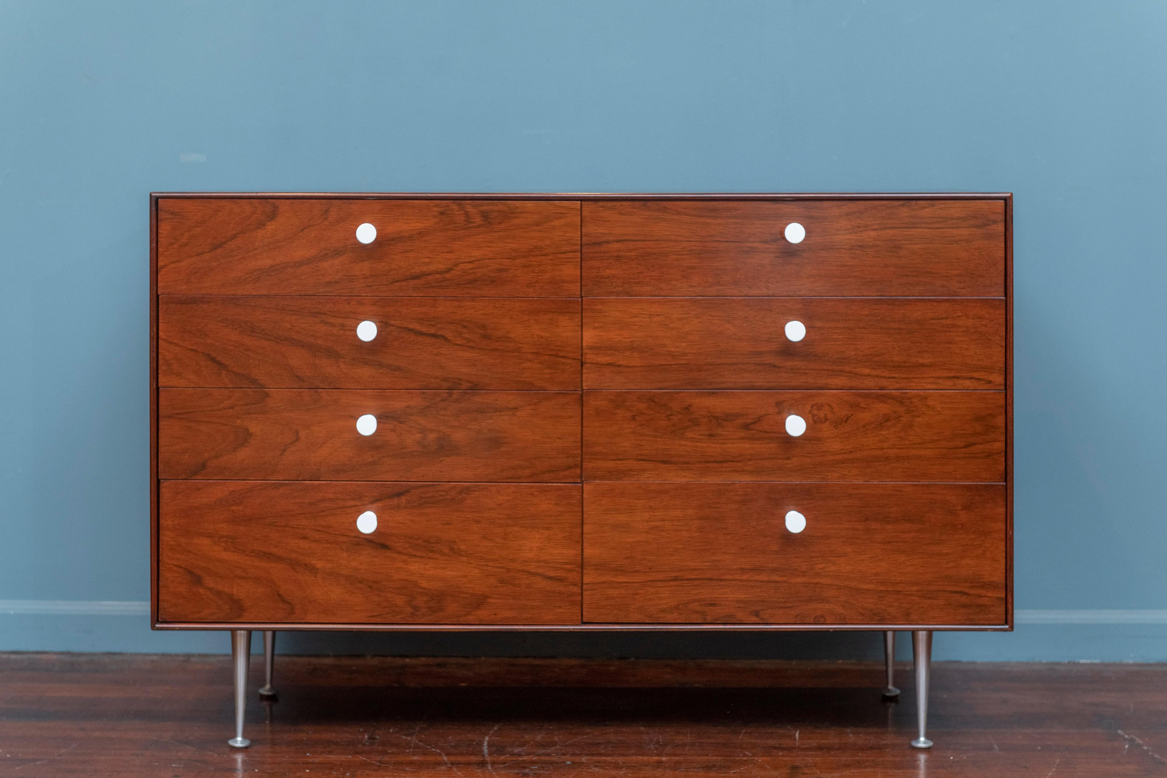George Nelson Thin Edge Group eight drawer dresser for Herman Miller.
Made with high quality construction and detail in Brazilian rosewood and oak with drawer dividers to help with organization. White conical drawer pulls on original tapering