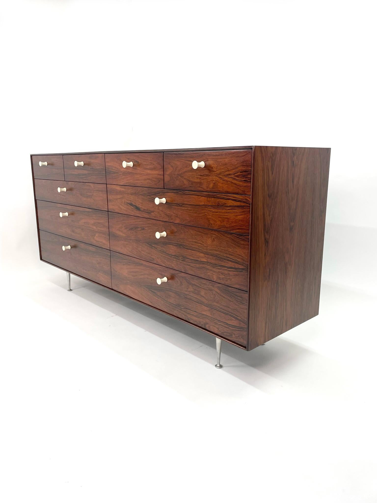 George Nelson Rosewood Thin Edge Double Dresser for Herman Miller. Newly refinished 10 drawer rosewood dresser with white coated aluminum pulls on tapered aluminum legs. The front of the drawers feature book matched grain across the front given a