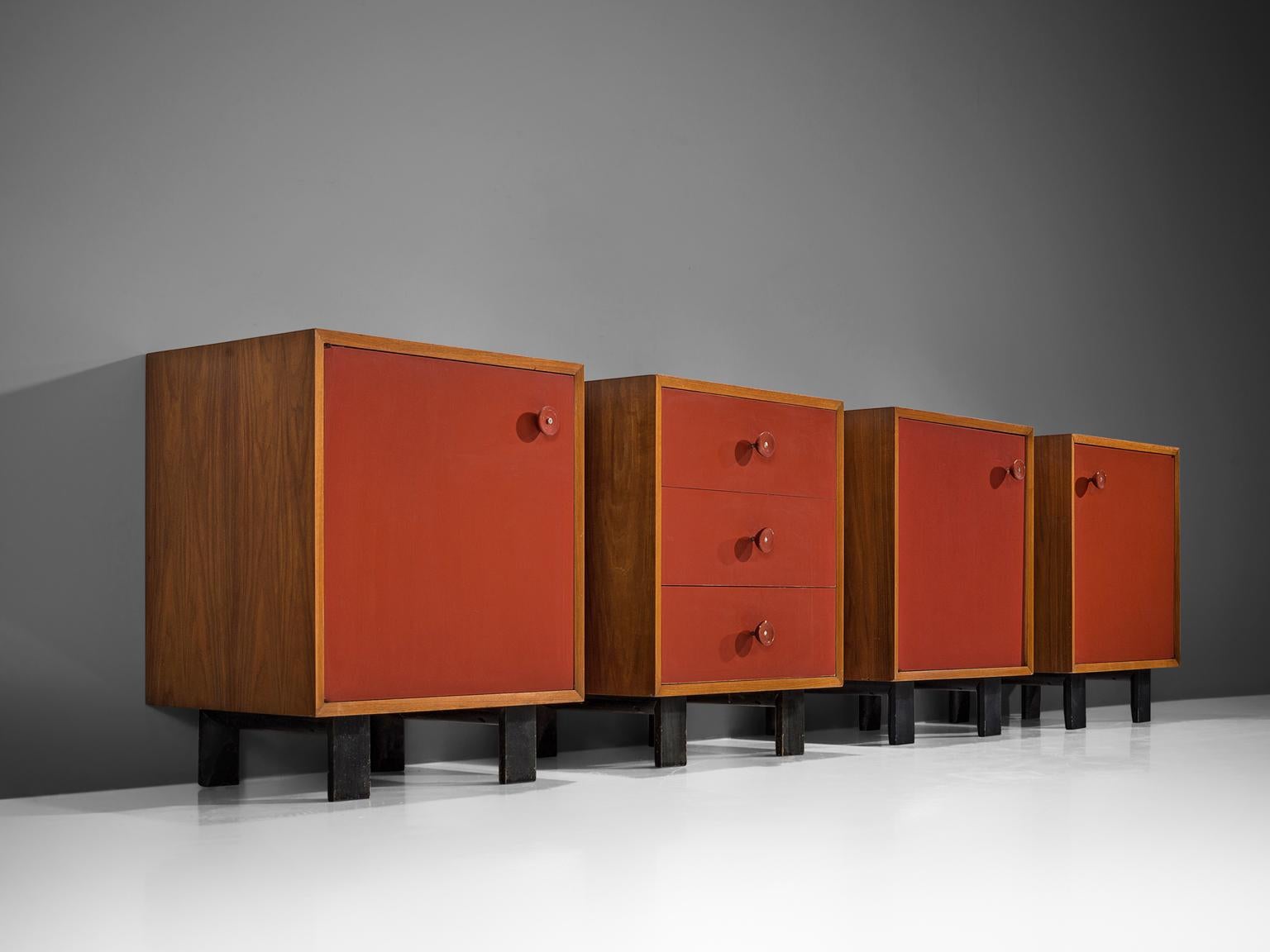 George Nelson for Herman Miller Zeeland Michigan, set of four cabinets in teak and patinated black wood, United States, 1950s. 

This four set of cabinets present patinated red color doors, which blend nicely with the light color of the teak. On the