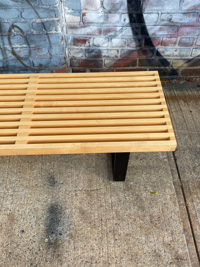 Gorgeous slat bench designed by George Nelson and manufactured by Herman Miller. Maple slats atop black wood frame constructing the perfect bench or coffee table for your home. The timeless and iconic American modern design dates to the 1940s but