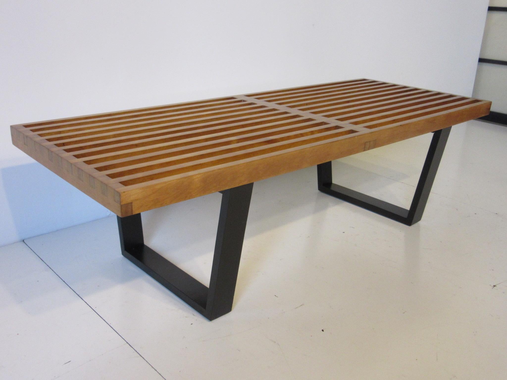 A Nelson platform bench or coffee table with natural birch wood slat top and black ebony finished legs. Perfect for the end of the bed, entrance way or living space, manufactured by the Herman Miller Furniture Company.