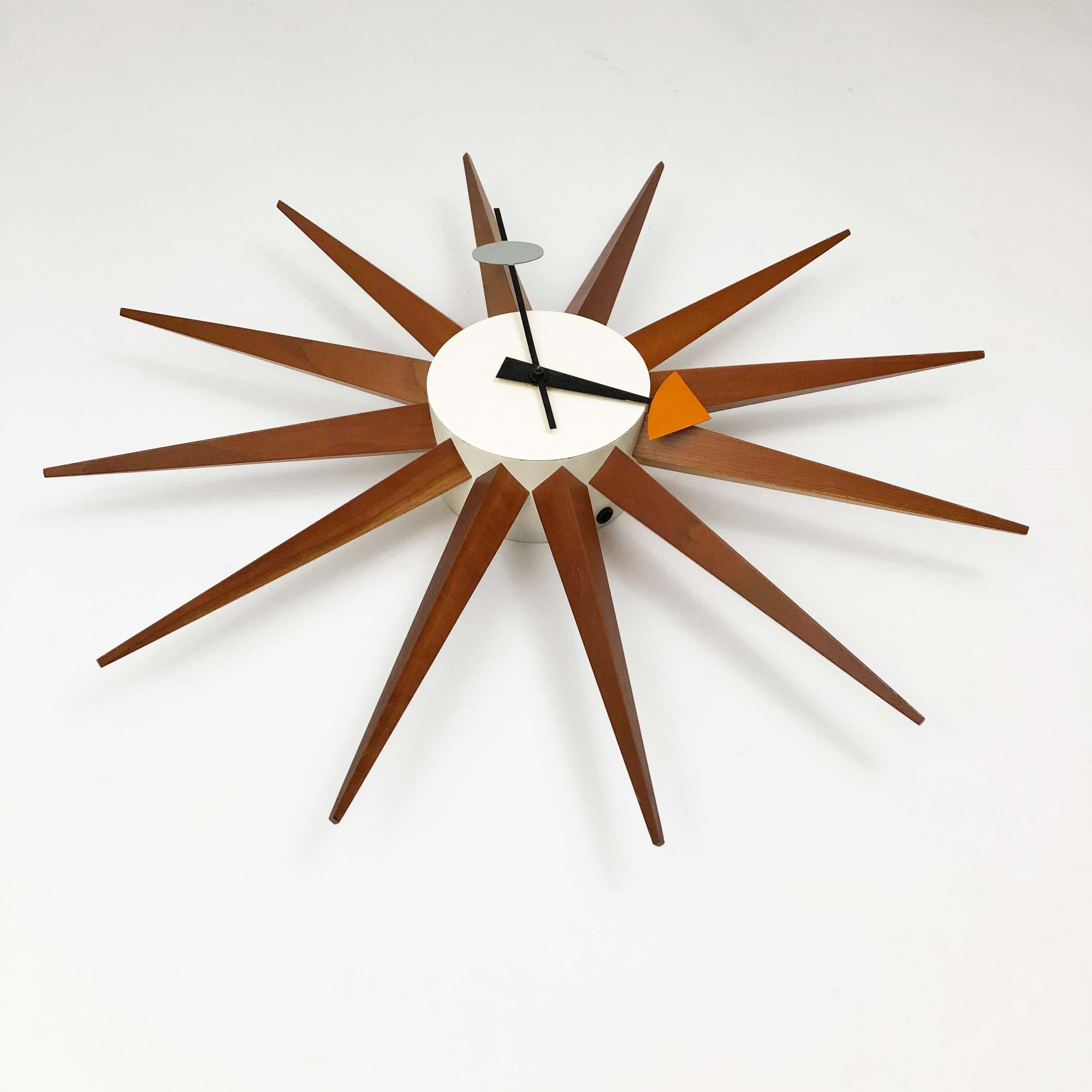 Striking classic George Nelson Model 2202 spike sunburst clock for Howard Miller. 

Walnut and enameled metal. Very good original condition.

Original Synchron movement. See photo.

The original pigtail cord has been replaced with an 8-foot