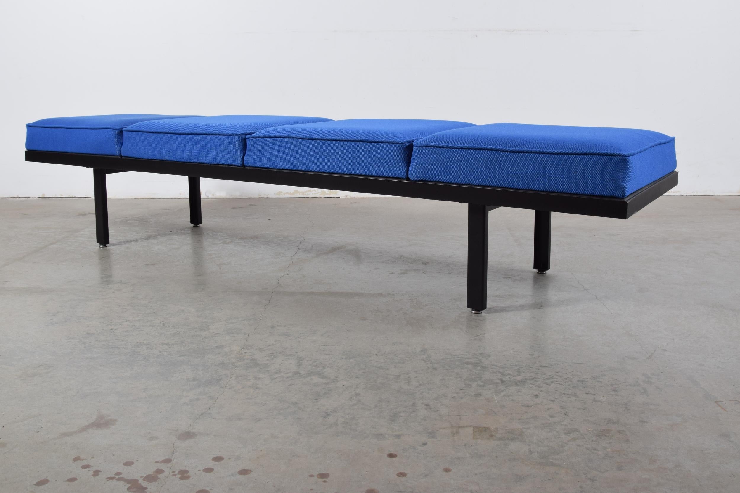 Steel frame bench designed by George Nelson for Herman Miller, circa 1956. Bench has been newly upholstered in Maharam Steelcut Trio blue wool fabric. Bench measures 80 3/4