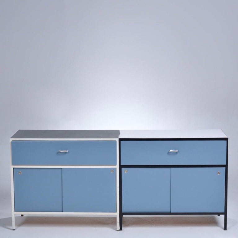 First year production George Nelson Steel Frame Case series cabinet. 

Sky blue sides and facade available with either the white steel frame/black linoleum top configuration or the black steel frame/white top configuration. 
The cabinets feature one