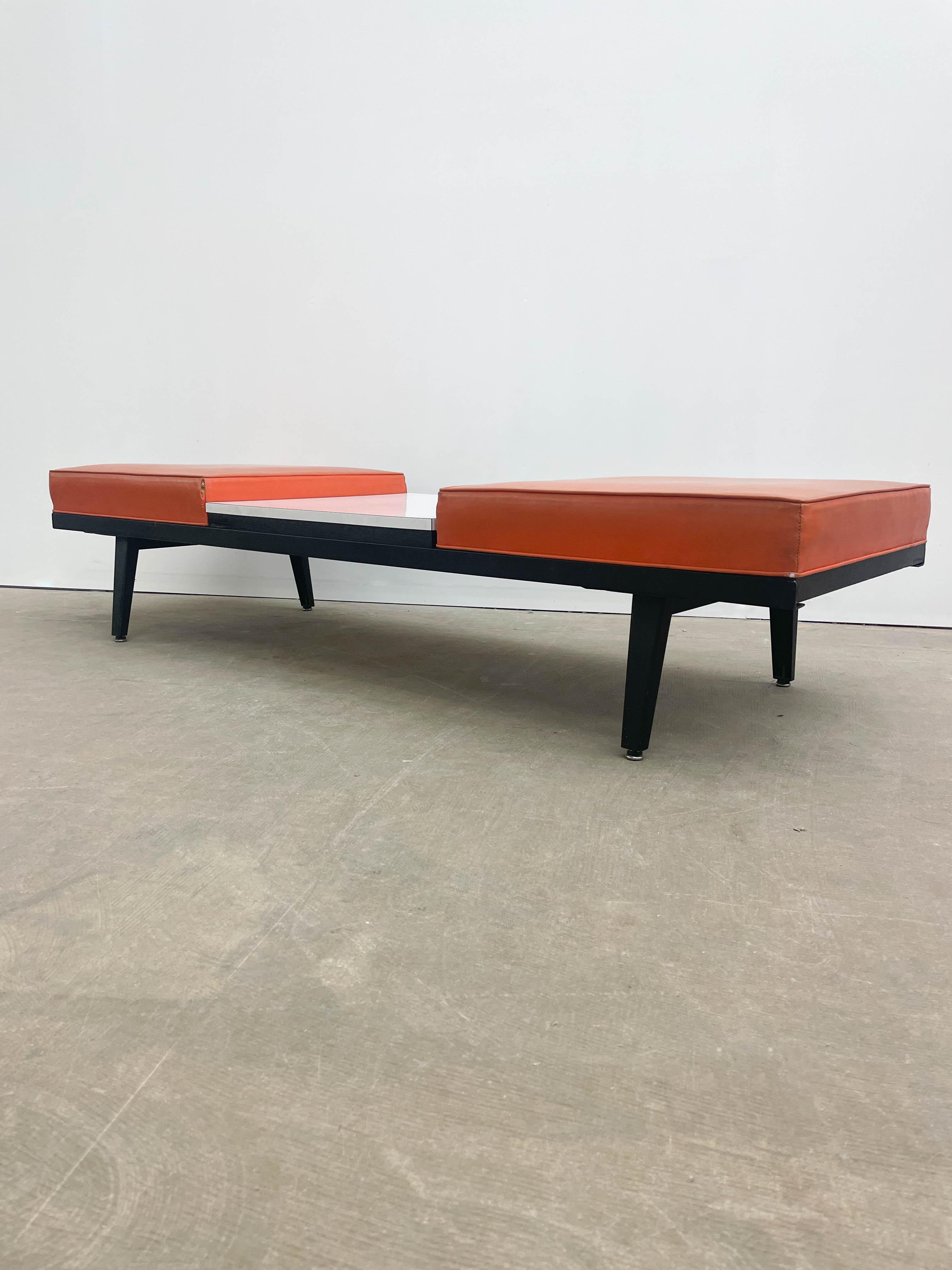 This piece is part of the George Nelson Steelframe series from the early 1950s, made by Herman Miller. The set consists of a three-module Steelframe bench with a pair of flat foam seating modules and one Formica-topped table module. The upholstery