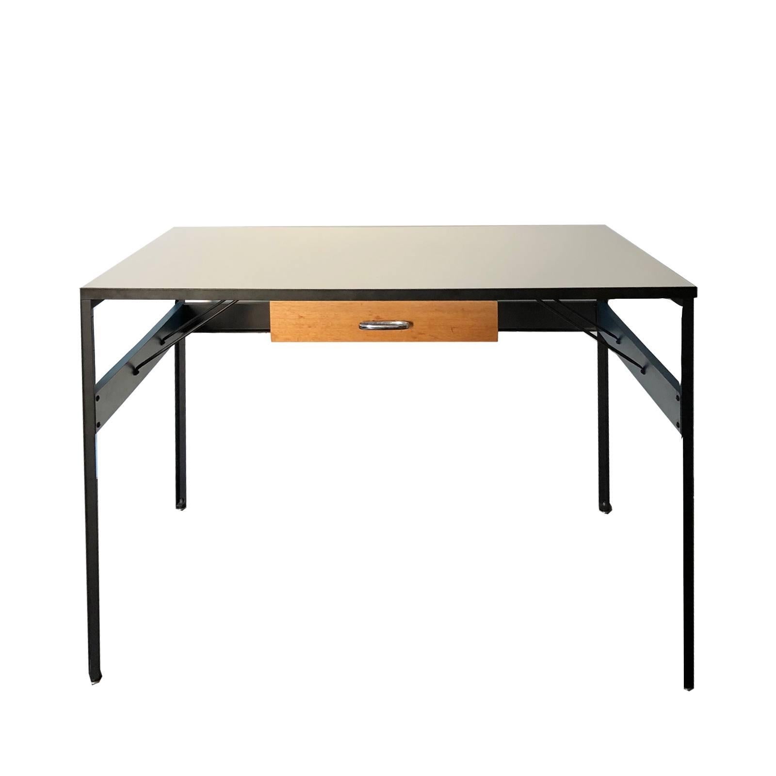 Iconic George Nelson Steelframe desk for Herman Miller. Top is a white laminate and steelframe is black enameled. Sides feature a blue painted wood frame. This is a quite an uncommon form with central drawer.
 