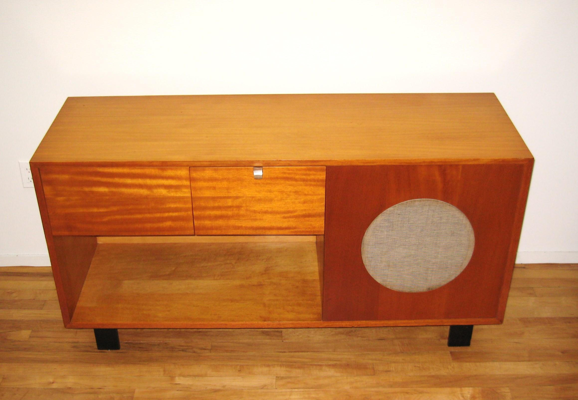 Mid-Century Modern cabinet console designed by George Nelson manufactured by Herman Miller features original turntable with Original Meissner tube radio amplifier. Looks intact, the equipment will need restoration. This will be a wonderful addition