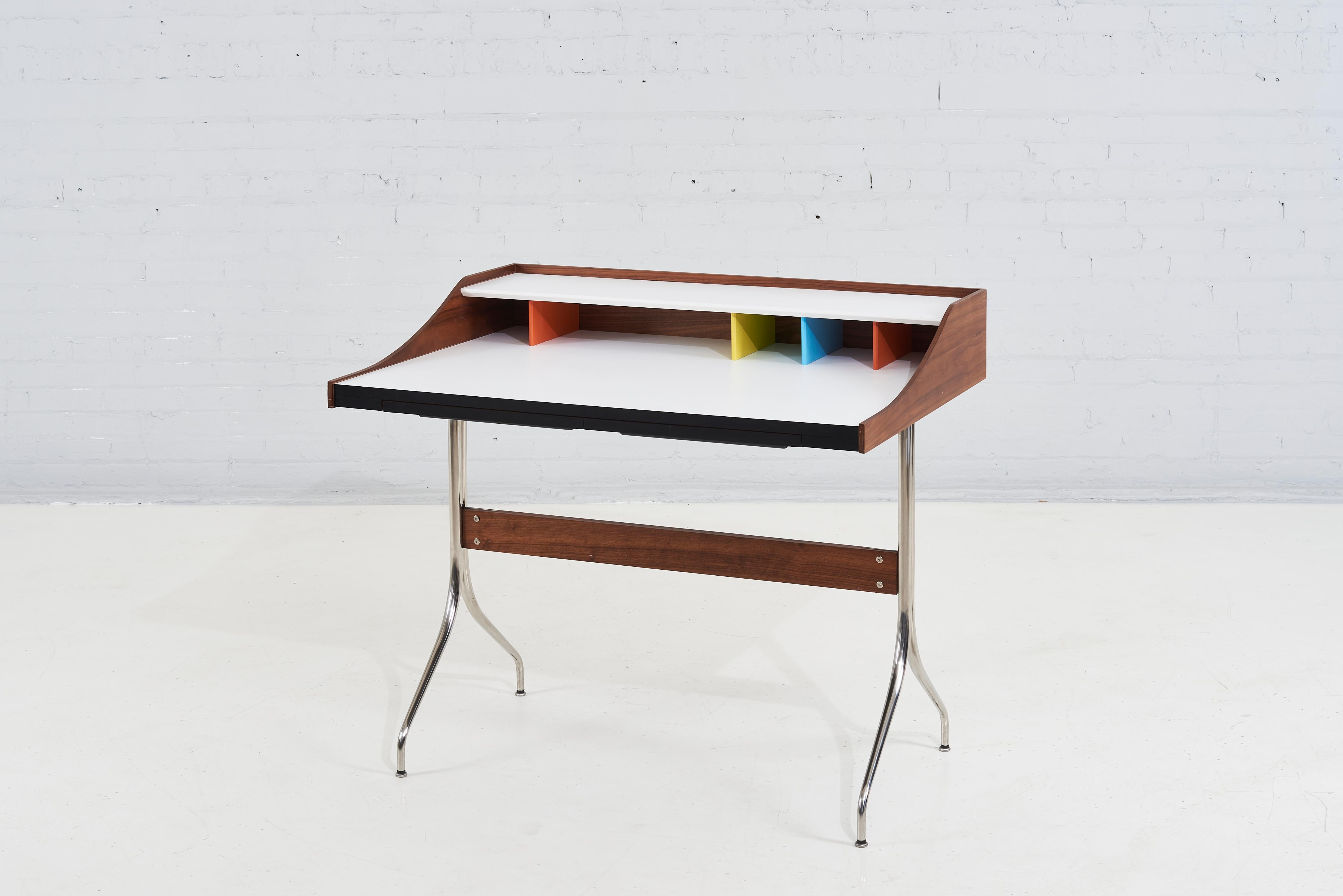 George Nelson swag leg desk. Ample space for writing, typing or sketching, the swag leg desk also offers colorful cubbies for desktop organization and a shelf.
