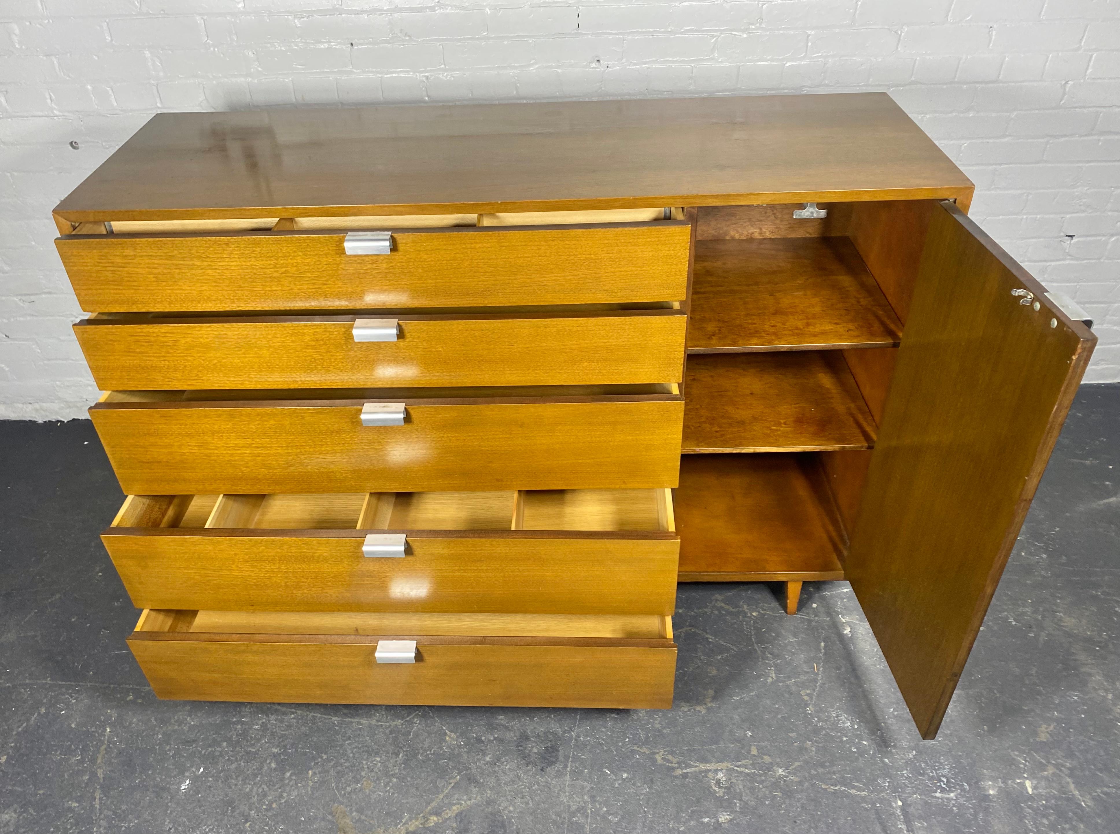 Nice early George Nelson 'Thin Edge' chest of drawers with classic aluminum pulls  and walnut or mahogany veneer. Divided drawers,,, Produced in the  1950s & 1960s by Herman Miller, the cabinet and drawers retain its original condition.. nice warm