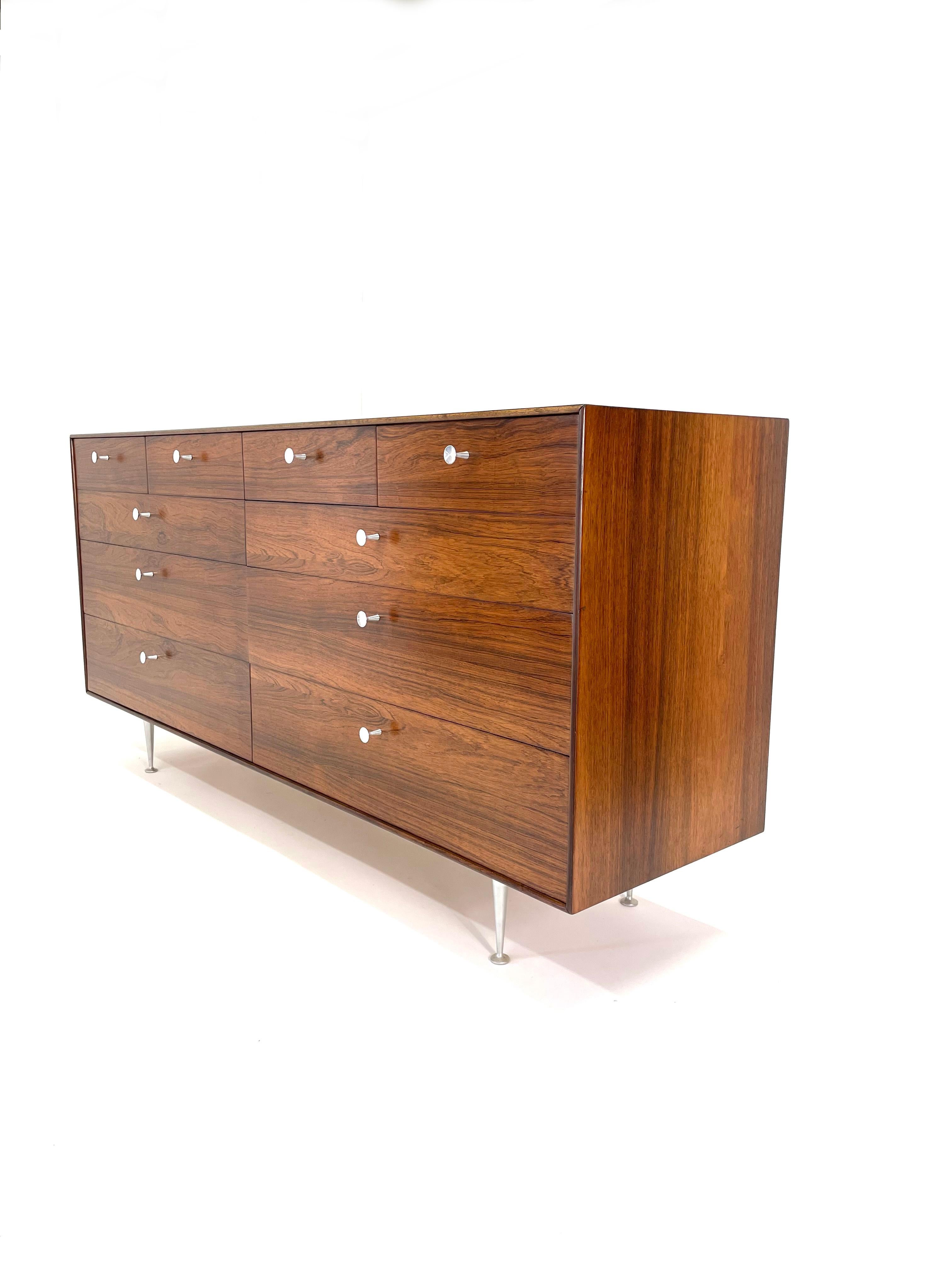 This George Nelson Rosewood Thin Edge Double Dresser for Herman Miller is as elegant and extraordinary as it comes. Newly refinished 10 drawer dresser with original aluminum pulls on tapered aluminum legs. This piece is a classic understated Modern