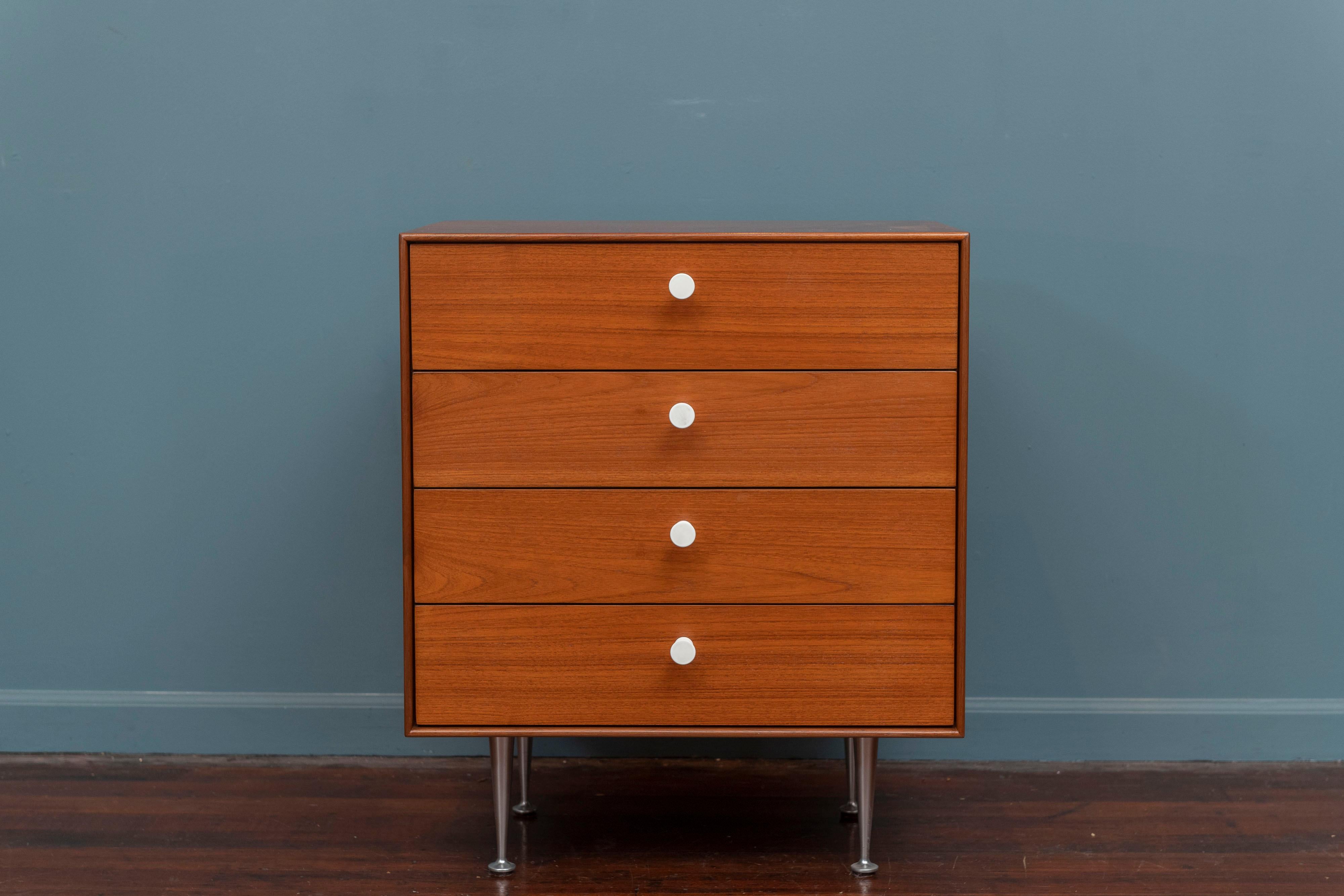 George Nelson Thin Edge dresser for Herman Miller. Rare small four drawer chest in teak with porcelain pulls and tapered aluminum legs, labeled.
