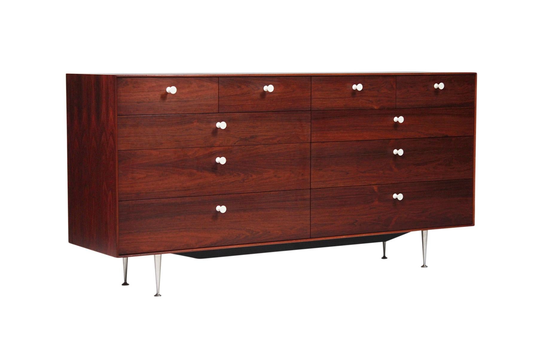 George Nelson for Herman Miller ten-drawer thin edge dresser. bookmatched rosewood veneers with porcelain pulls and tapered aluminum legs. Rare example of the iconic series. White metal Herman Miller label in drawer interior.