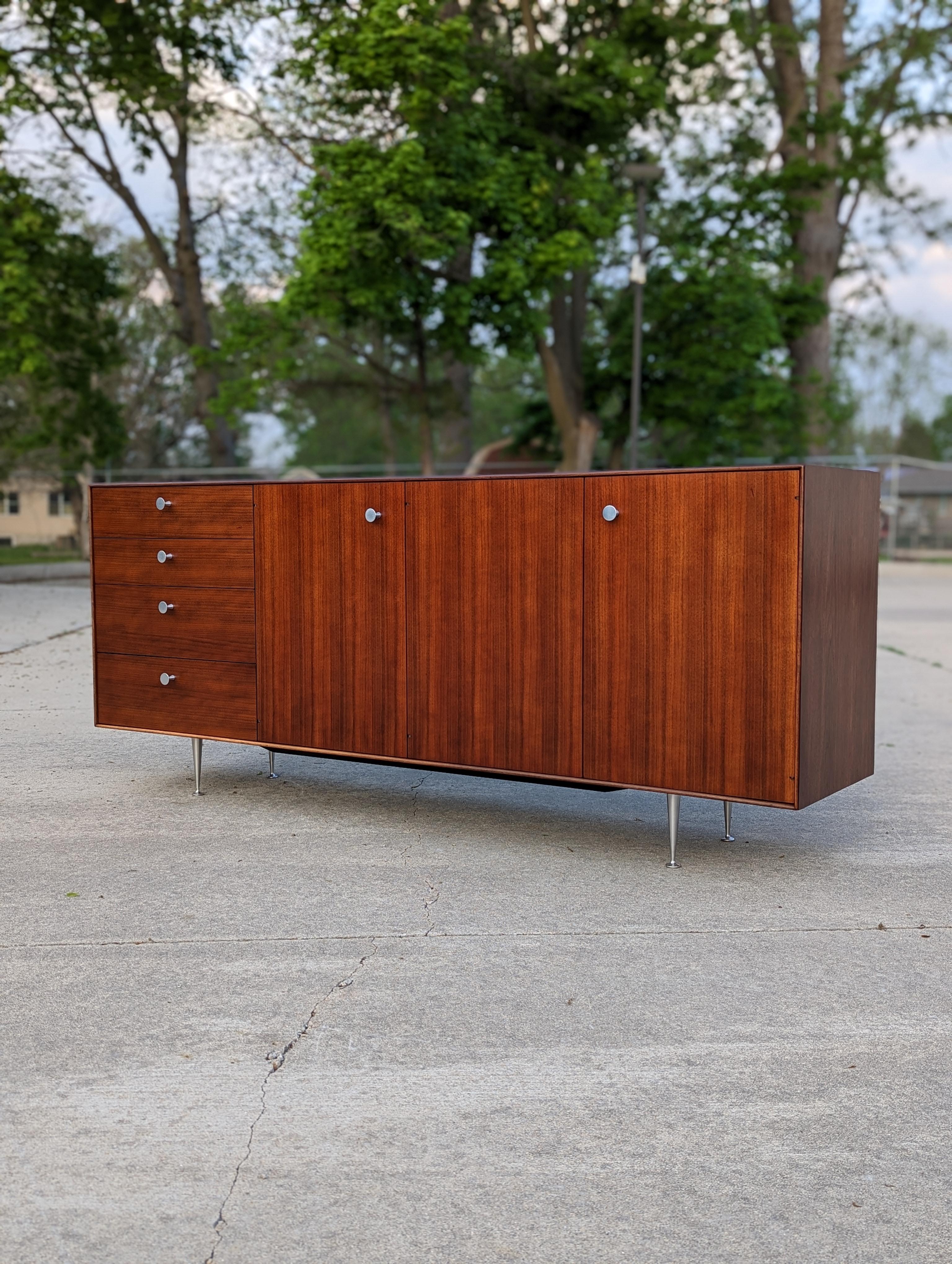 Beautiful George Nelson for Herman Miller thin edge sideboard / credenza. Walnut case in excellent condition. Large proportions and plenty of room for storage with 4 drawers, one hidden drawer, 3 compartments, 2 adjustable height shelves.

Please