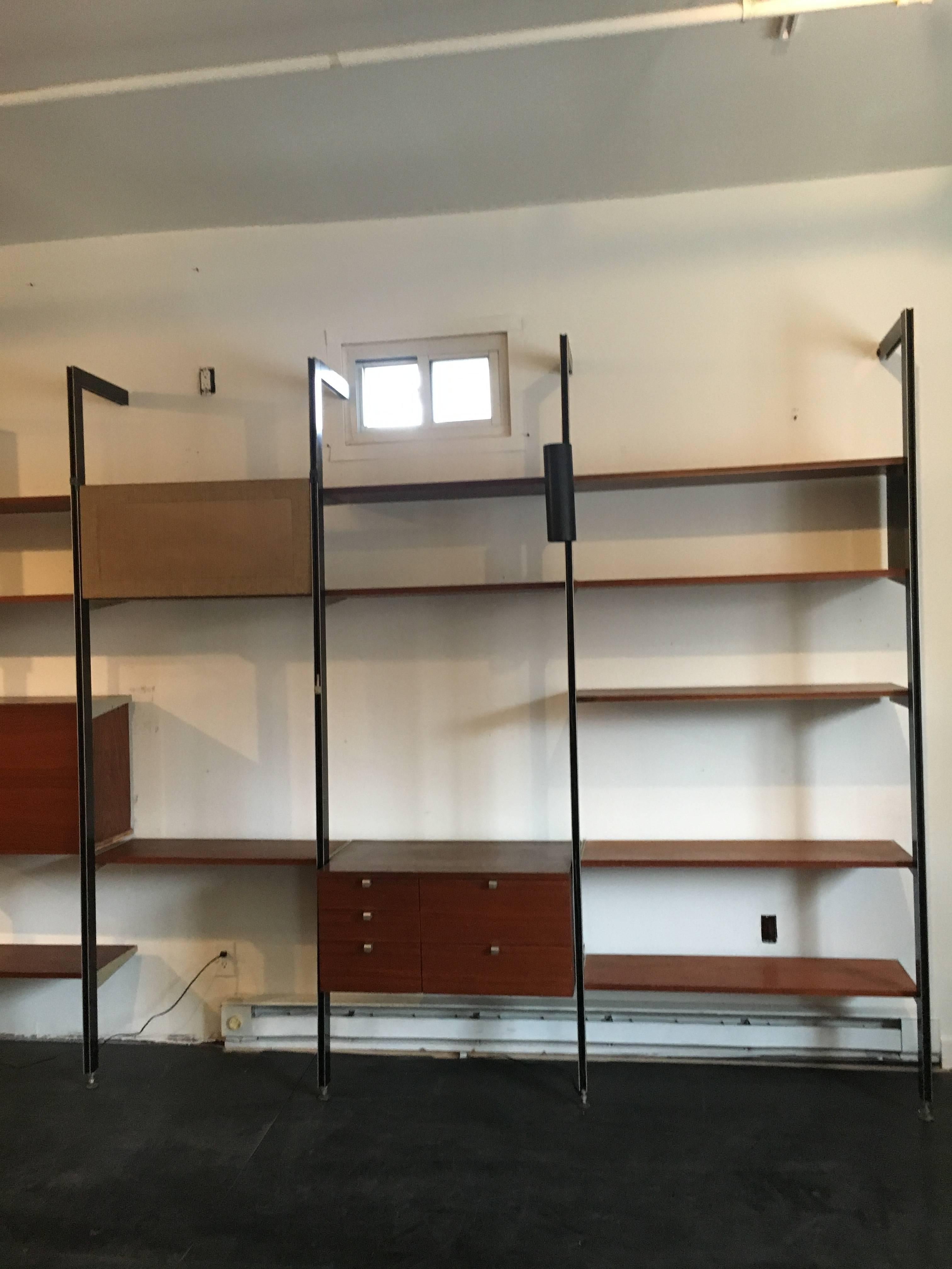 Three bay CSS, designed by George Nelson for Herman Miller, walnut shelves an cabinets.  

Our gallery specializes in George Nelson's CSS storage system of 1959. We currently have several bays available with many different cabinet, lighting, and