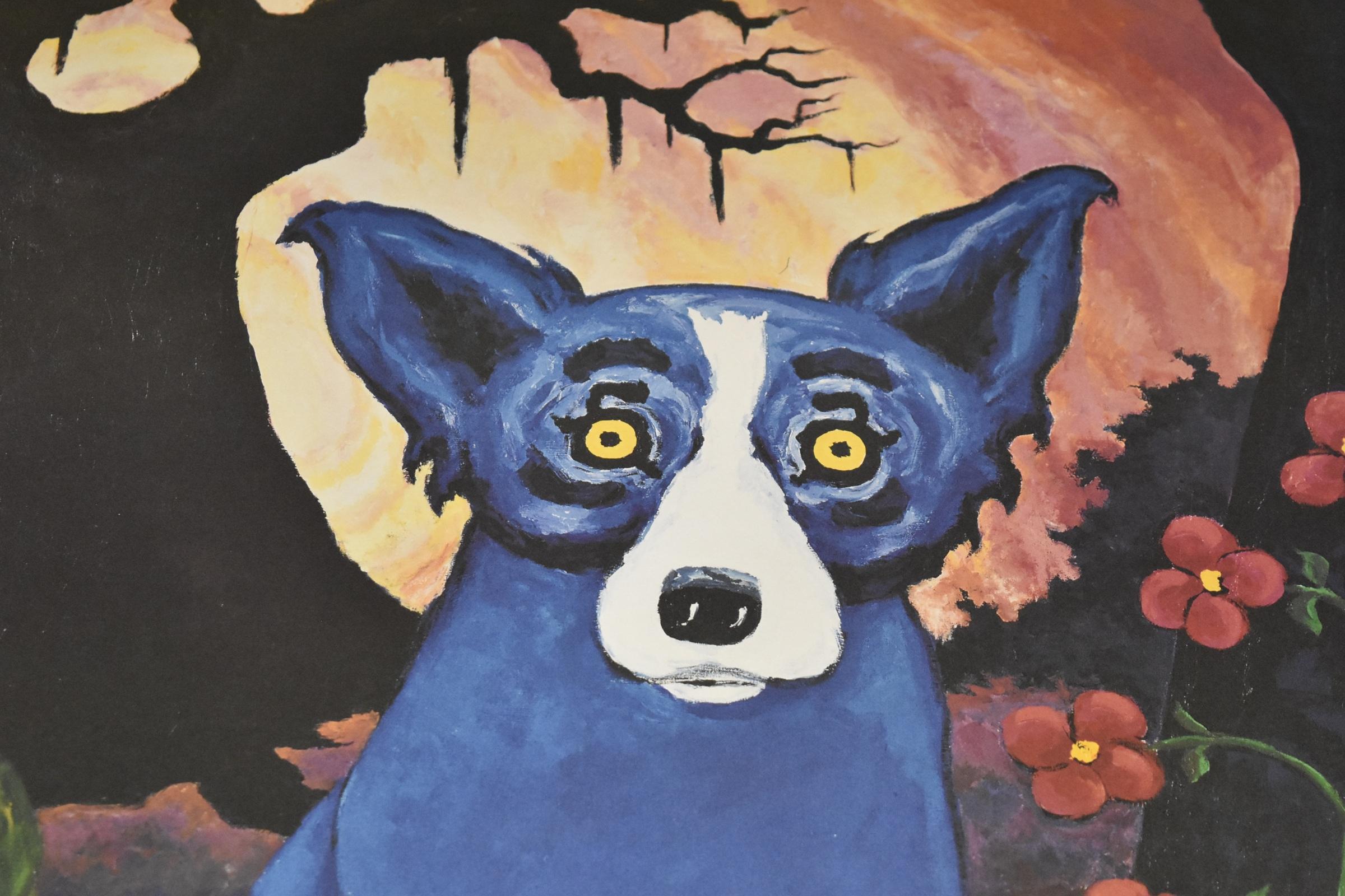 This Blue Dog work consists of a blue dog on a background of mountains, trees, and a red and yellow sky.  There is an alligator at the feet of the dog.  There is also an Absolut Vodka bottle with red flowers. The dog has soulful yellow eyes.  This