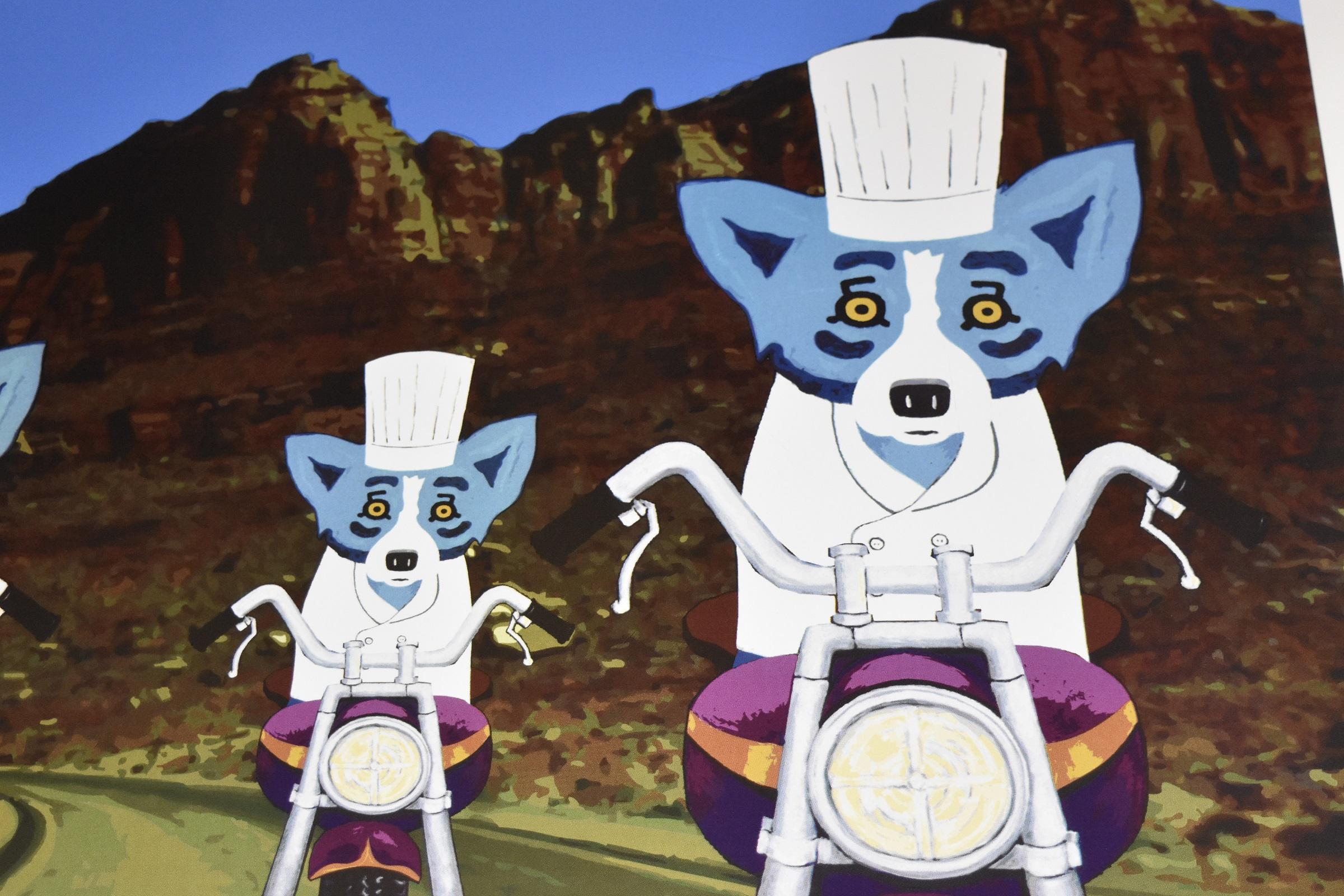 This Blue Dog Work consists of 3 blue dogs riding purple and chrome motorcycles and wearing chef white coats and hats, riding through the mountains of Utah on a beautiful sky blue day. The dogs all show confidence on their ride in their soulful